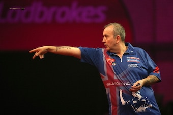 LONDON, ENGLAND - DECEMBER 20: Phil Taylor of England throws during his second round match against Michael Smith of England during the Ladbrokes.com World Darts Championship on Day Eight at Alexandra Palace on December 20, 2013 in London, England. (Photo LONDON, ENGLAND - DECEMBER 20: Phil Taylor of England throws during his second round match against Michael Smith of England during the Ladbrokes.com World Darts Championship on Day Eight at Alexandra Palace on December 20, 2013 in London, England. (Photo