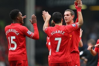 LIVERPOOL, ENGLAND - MARCH 30:  Jordan Henderson of Liverpool celebrates with his team-mates Daniel Sturridge (L) and Luis Suarez after scoring the fourth goal during the Barclays Premier League match between Liverpool and Tottenham Hotspur at Anfield on 