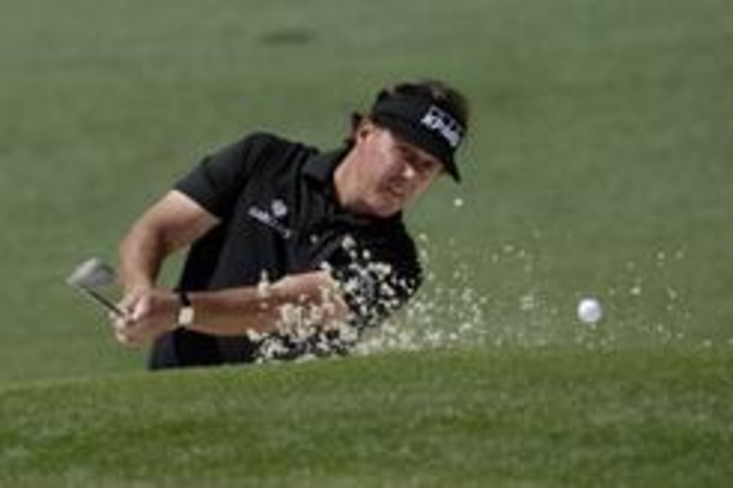 Apr 10, 2014; Augusta, GA, USA; Phil Mickelson hits out of a bunker on the 2nd hole during the first round of the 2014 The Masters golf tournament at Augusta National Golf Club. Mandatory Credit: Michael Madrid-USA TODAY Sports