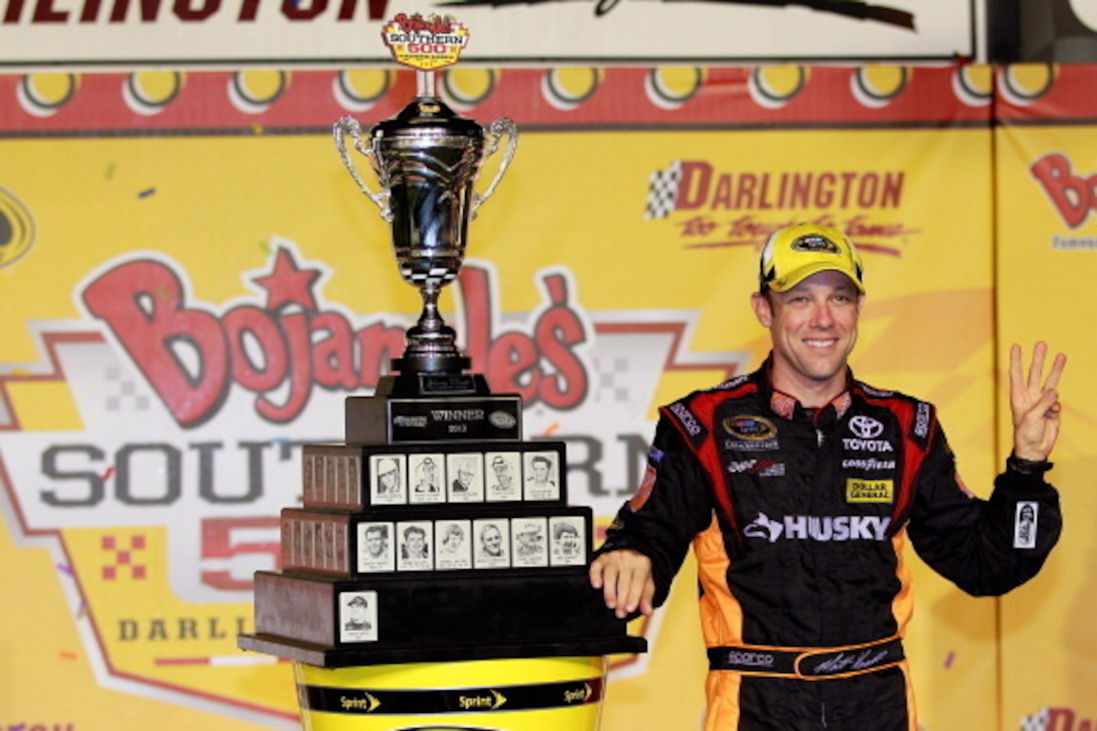 DARLINGTON, SC - MAY 11: Matt Kenseth, driver of the #20 The Home Depot / Husky Toyota, celebrates with the trophy in victory lane after winning the NASCAR Sprint Cup Series Bojangles' Southern 500 at Darlington Raceway on May 11, 2013 in Darlington, So DARLINGTON, SC - MAY 11: Matt Kenseth, driver of the #20 The Home Depot / Husky Toyota, celebrates with the trophy in victory lane after winning the NASCAR Sprint Cup Series Bojangles' Southern 500 at Darlington Raceway on May 11, 2013 in Darlington, So