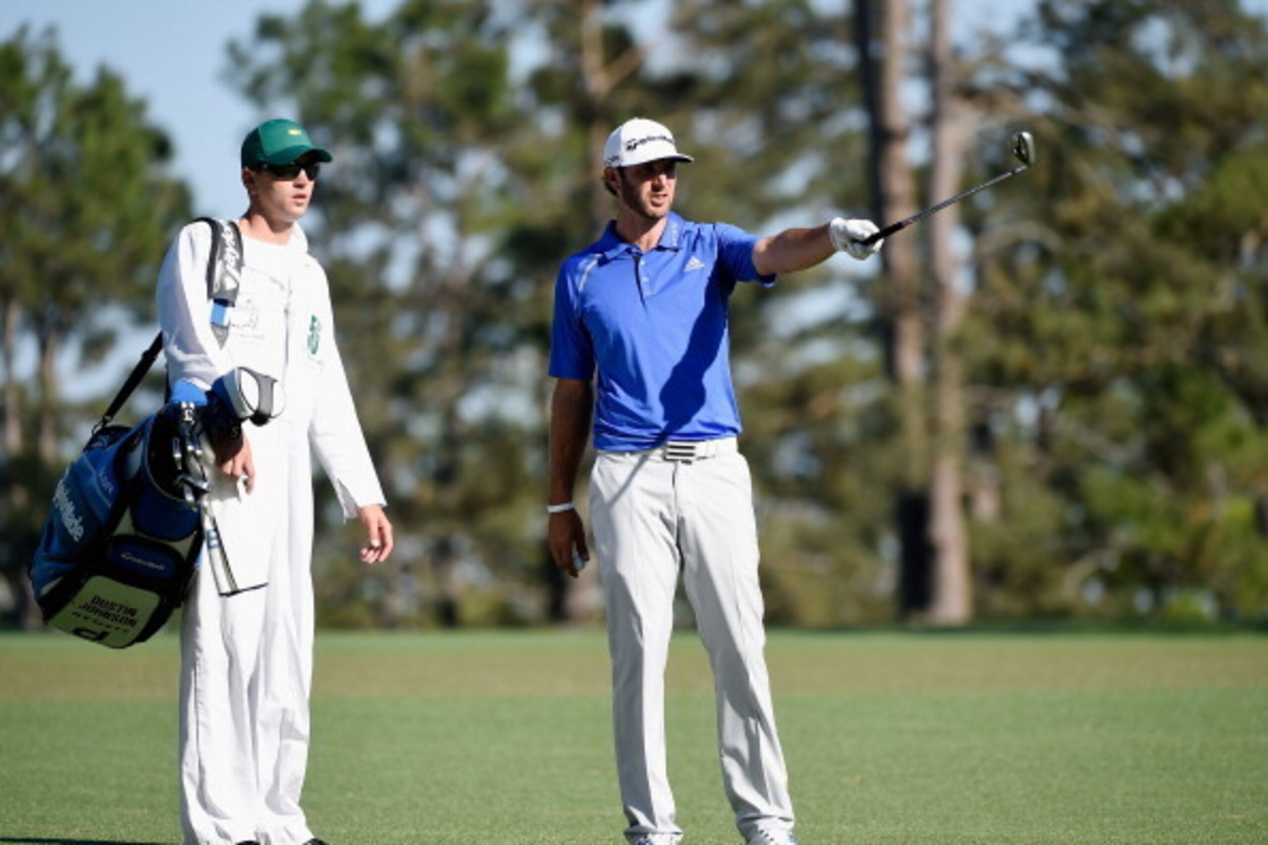 AUGUSTA, GA - APRIL 10:  Dustin Johnson of the United States lines up a shot with his caddie Austin Johnson on the 15th hole during the first round of the 2014 Masters Tournament at Augusta National Golf Club on April 10, 2014 in Augusta, Georgia.  (Photo