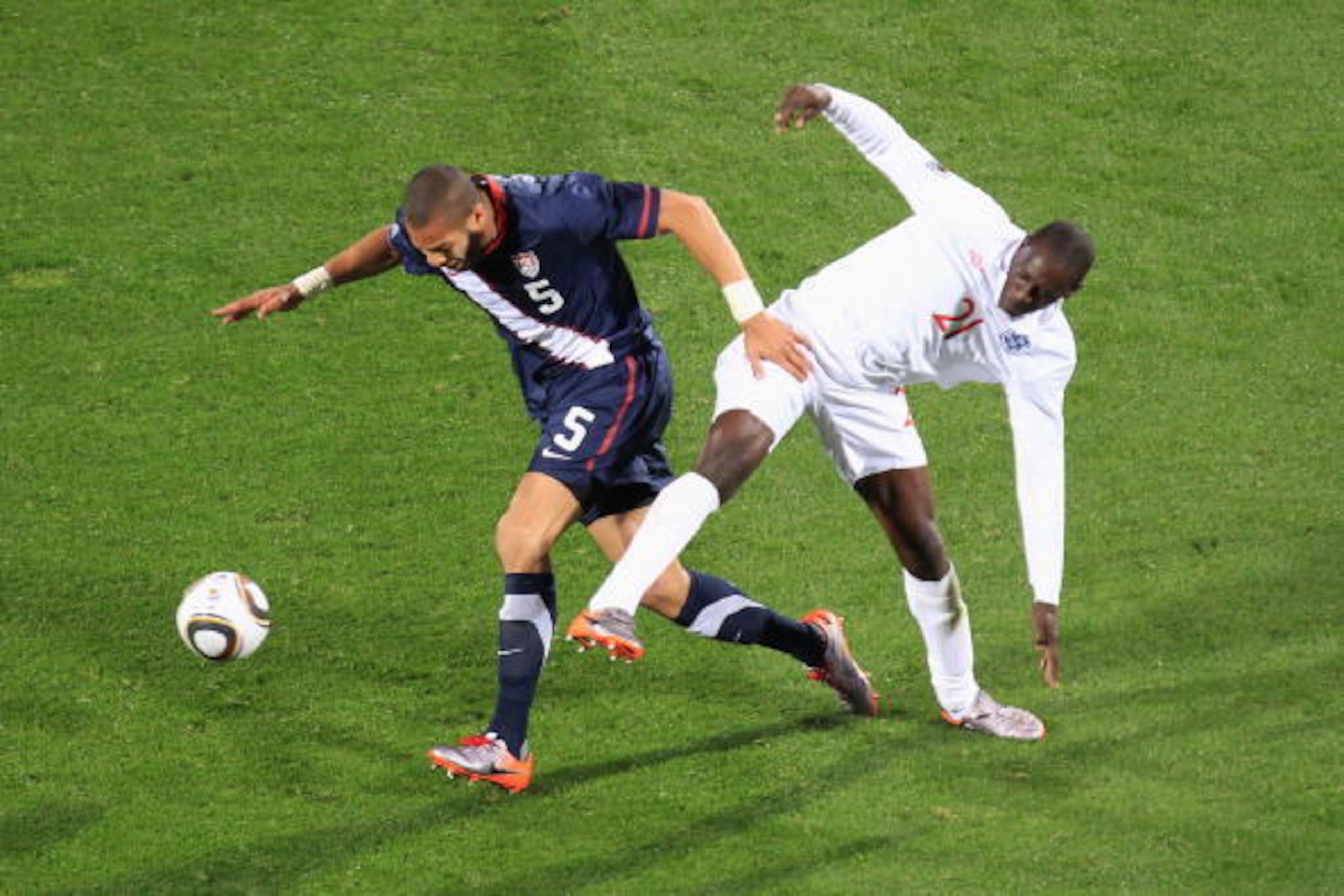 RUSTENBURG, SOUTH AFRICA - JUNE 12:  Oguchi Onyewu of the United States and Emile Heskey of England battle for the ball during the 2010 FIFA World Cup South Africa Group C match between England and USA at the Royal Bafokeng Stadium on June 12, 2010 in Rus