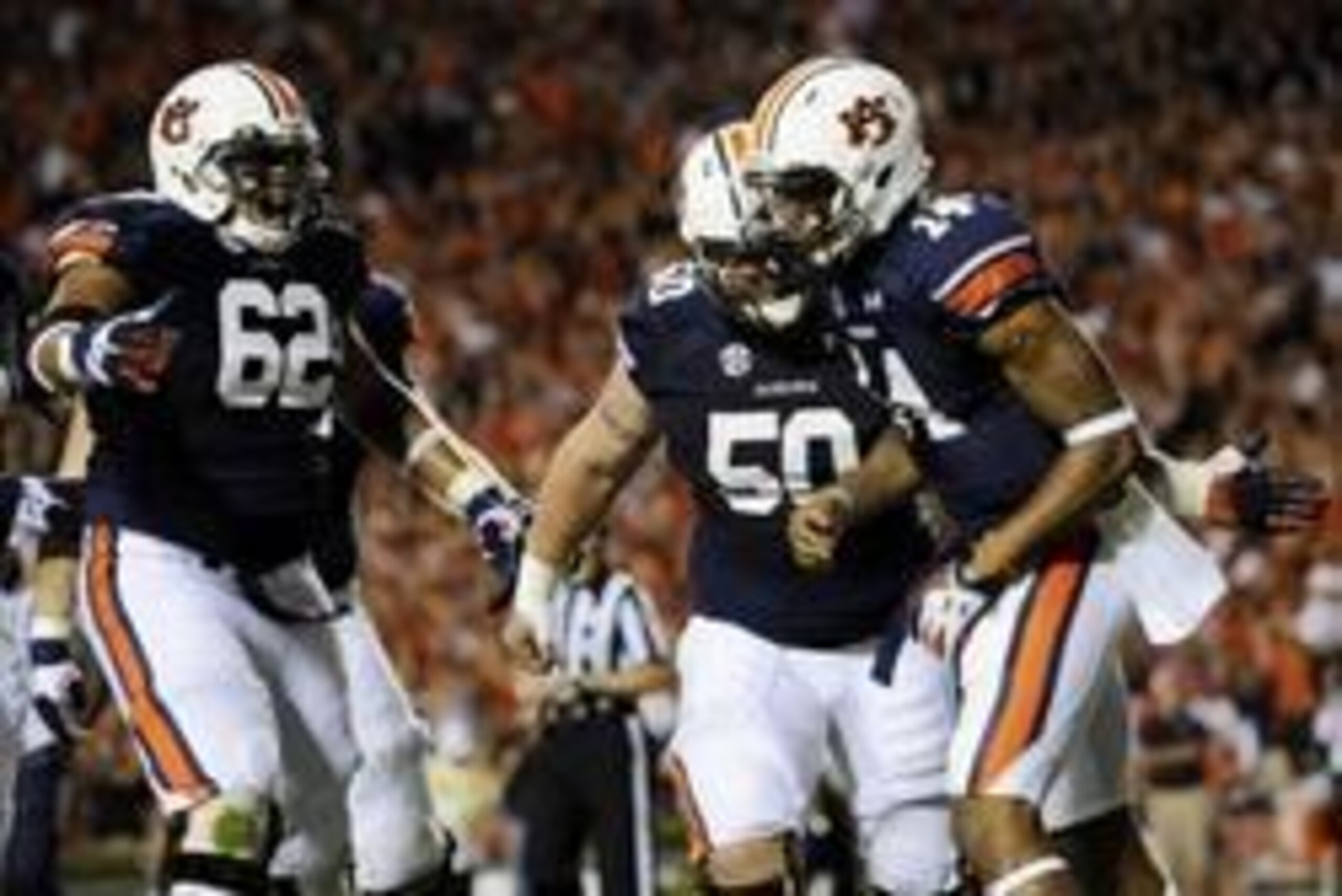 Oct 5, 2013; Auburn, AL, USA; Auburn Tigers quarterback Nick Marshall (14) celebrates his touchdown with offensive linesman Chad Slade (62) and Auburn Tigers defensive tackle Ben Bradley (50) during the second quarter against the Mississippi Rebels at Jor
