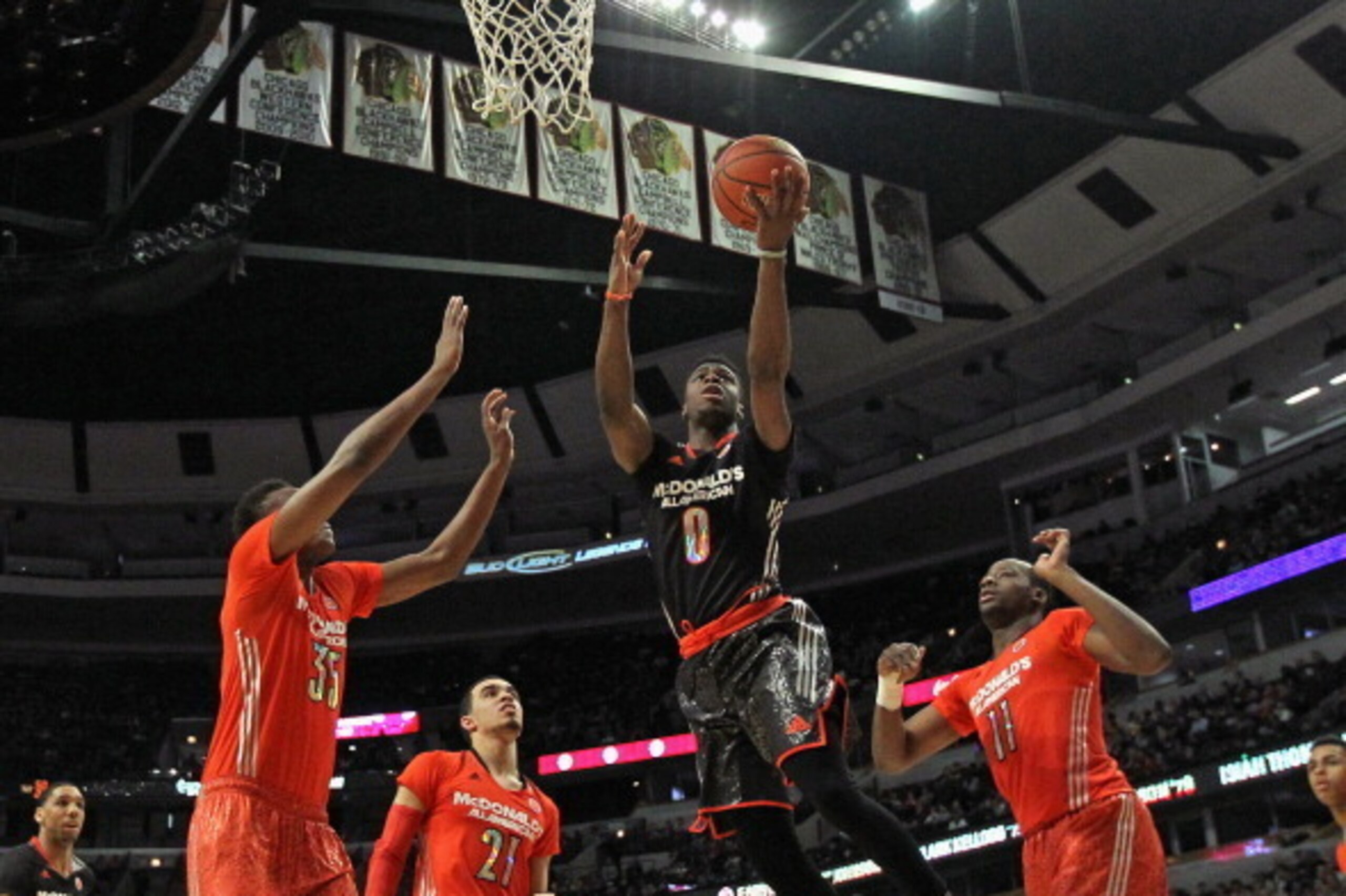 CHICAGO, IL - APRIL 02:  Emmanuel Mudiay #0 of the west team goes up for a shot between (L-R) Myles Turner #35, Tyus Jones #21 and Cliff Alexander #11 of the east team during the 2014 McDonald's All American Game at United Center on April 2, 2014 in Chica