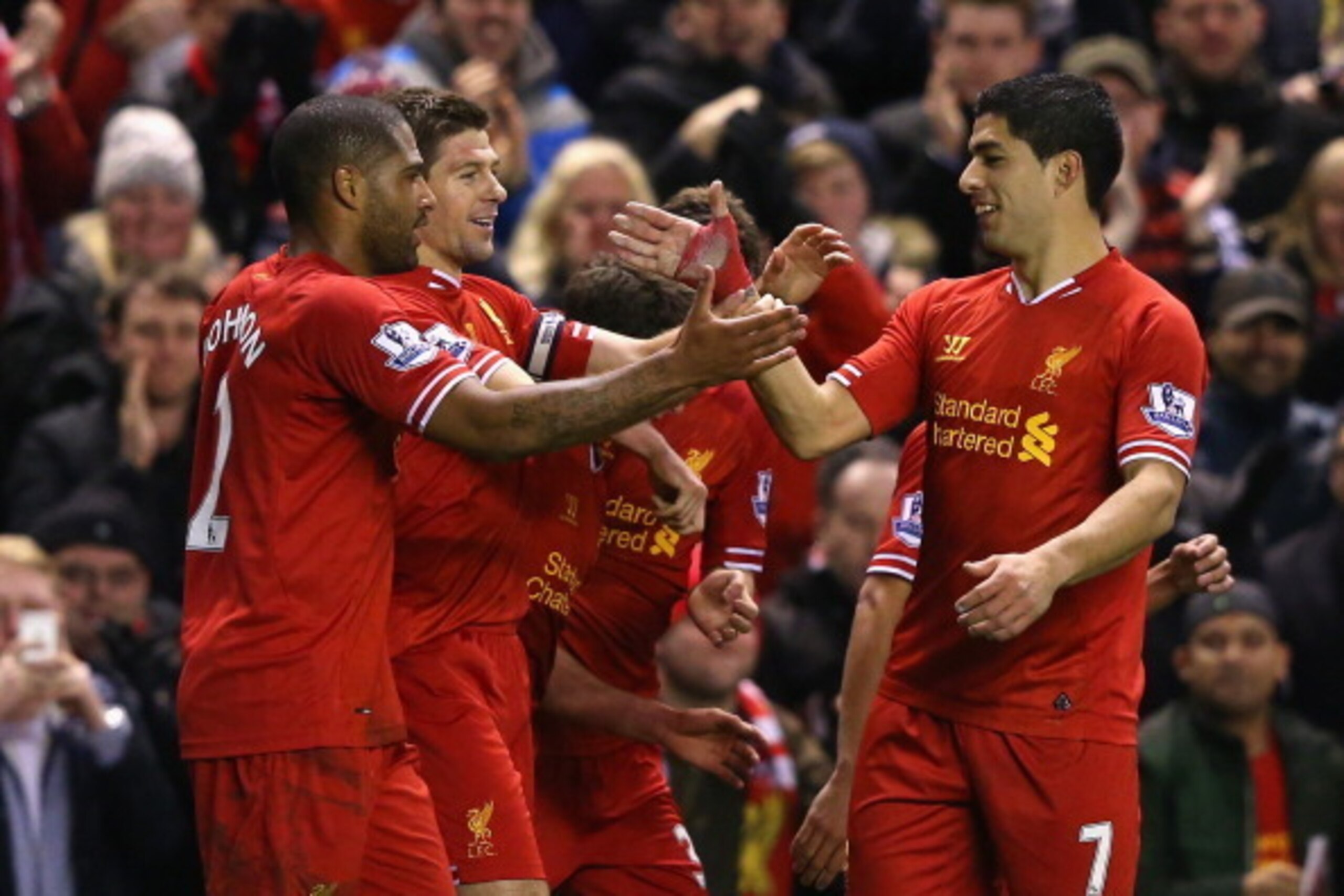 LIVERPOOL, ENGLAND - MARCH 26:  Steven Gerrard of Liverpool celebrates scoring the first goal with team-mate Luis Suarez (R) during the Barclays Premier League match between Liverpool and Sunderland at Anfield on March 26, 2014 in Liverpool, England.  (Ph