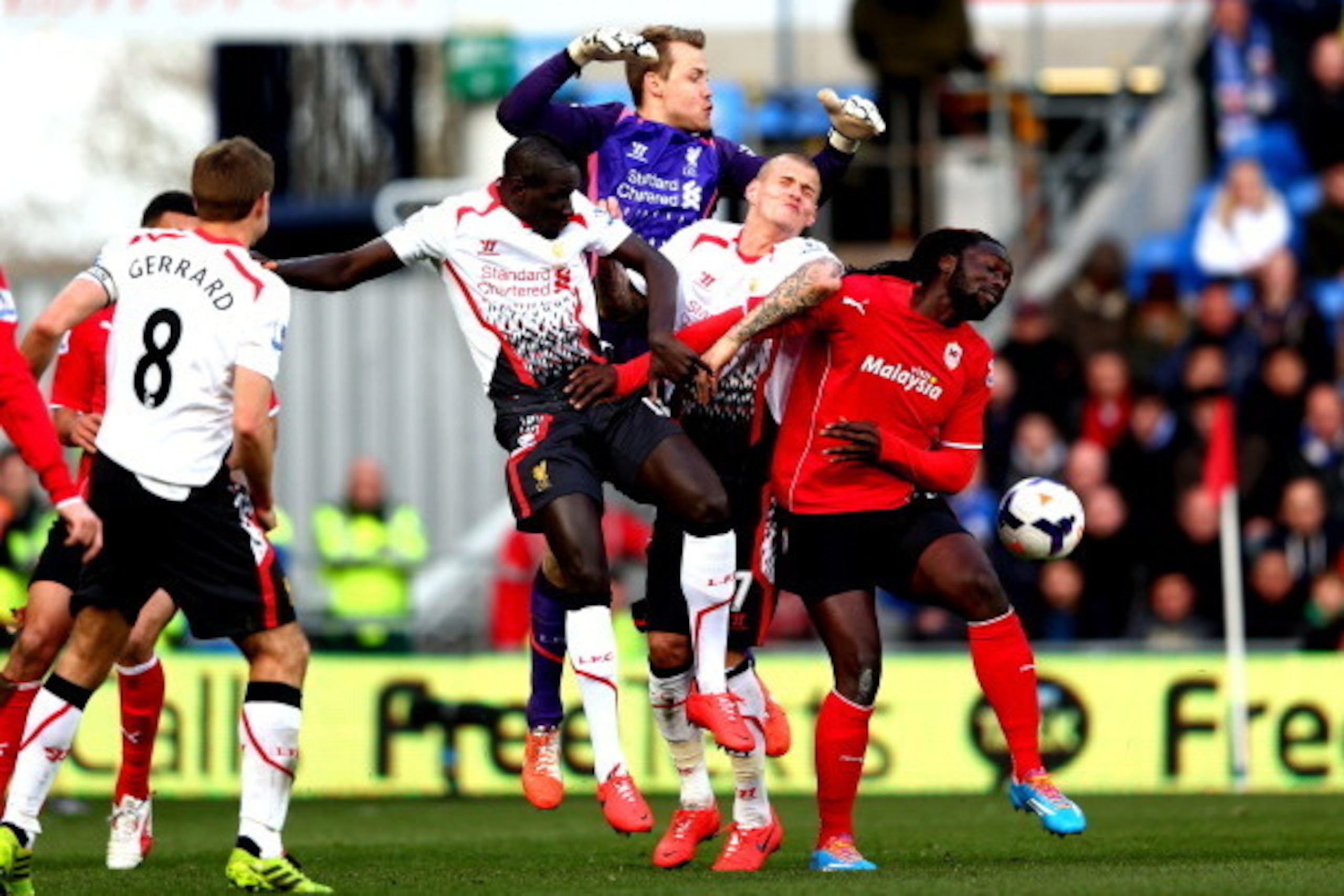 CARDIFF, WALES - MARCH 22:  Kenwyne Jones of Cardiff City battles for the ball with (L-R) Aly Cissokho, Simon Mignolet and Martin Skrtel of Liverpool during the Barclays Premier League match between Cardiff City and Liverpool at Cardiff City Stadium on Ma