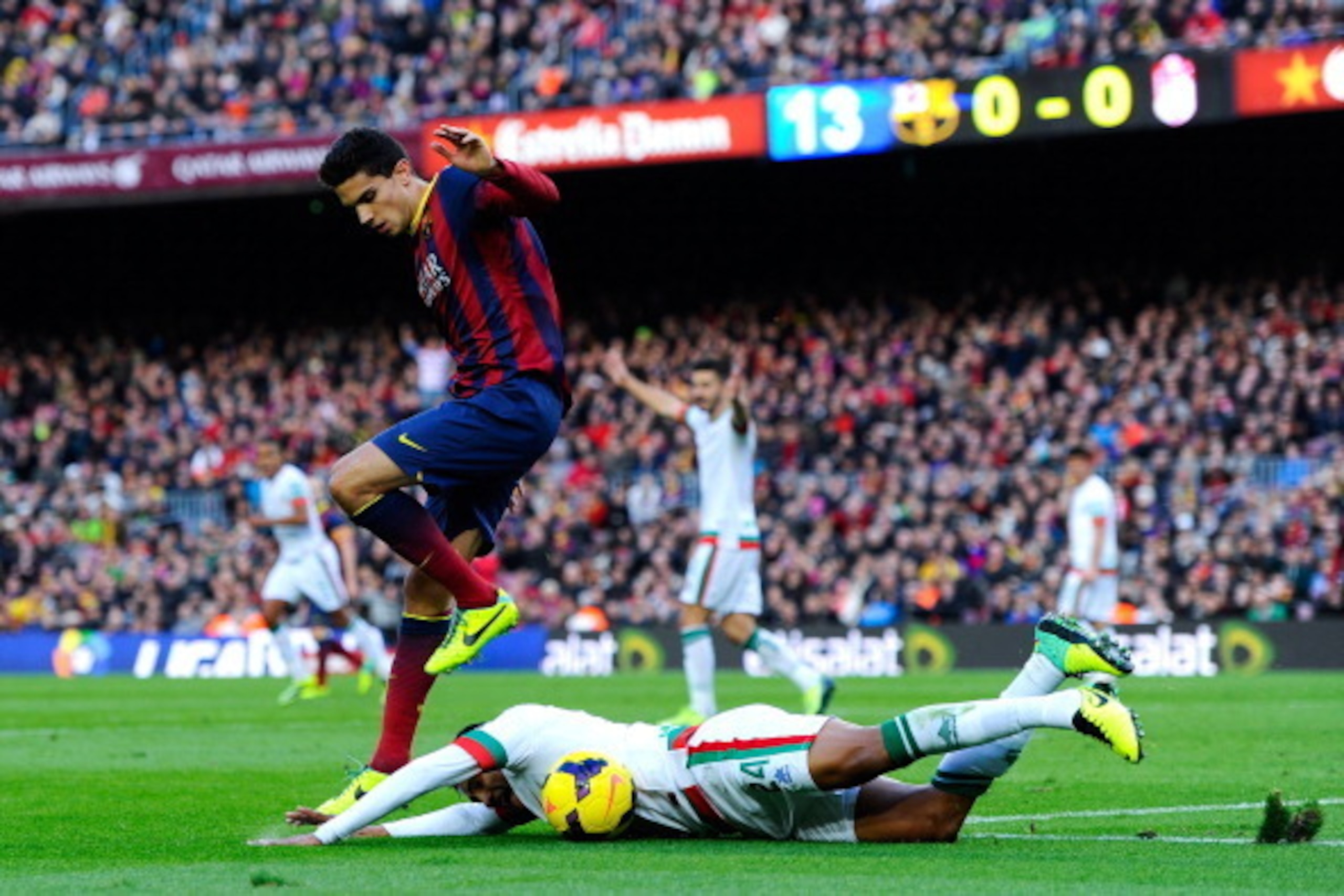 BARCELONA, SPAIN - NOVEMBER 23:  Marc Bartra of FC Barcelona fights for the ball Murillo of Granada CF with the La Liga match between FC Barcelona and Granda CF at Camp Nou on November 23, 2013 in Barcelona, Spain.  (Photo by David Ramos/Getty Images)