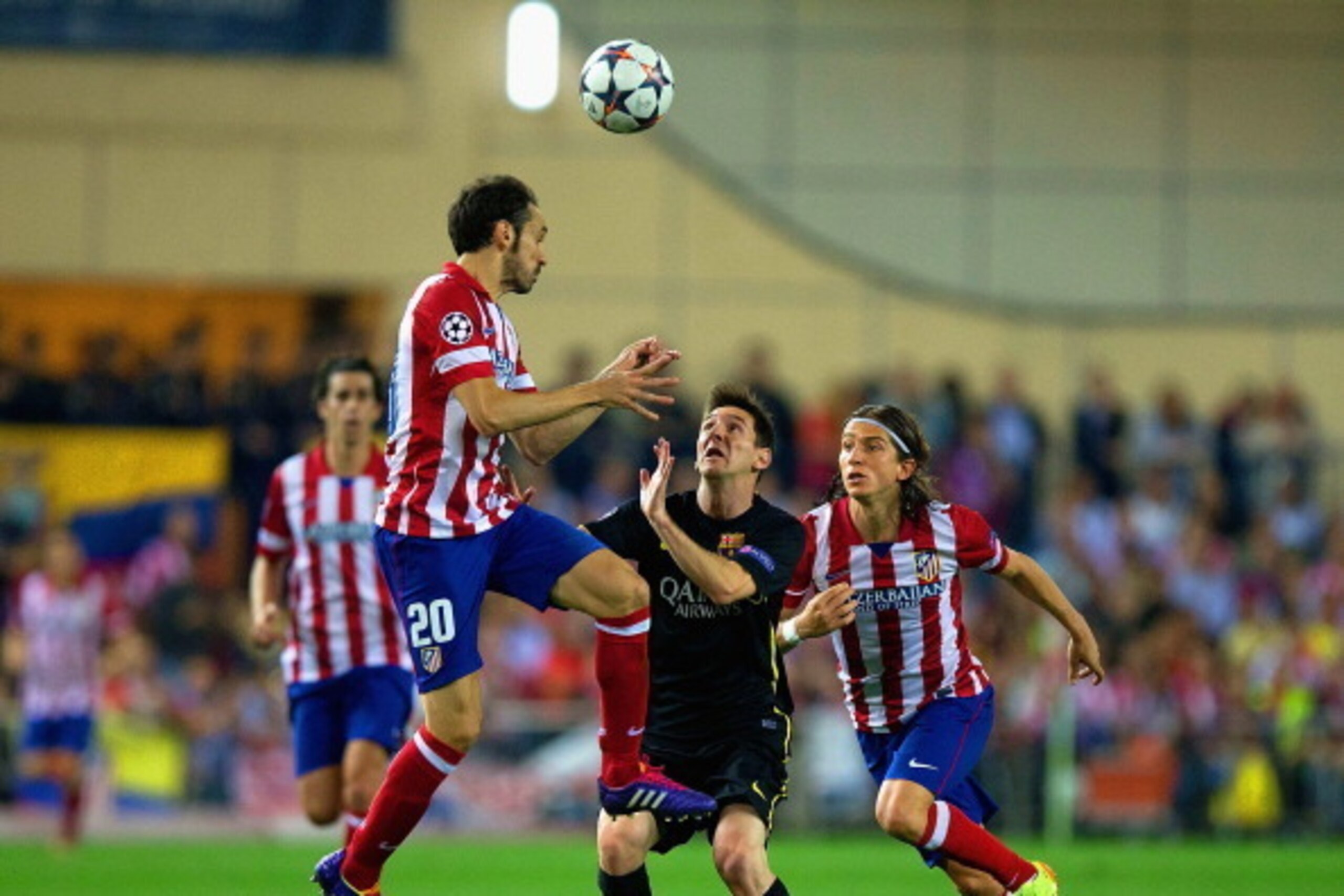 MADRID, SPAIN - APRIL 09: Juanfran of Club Atletico de Madrid climbs above Lionel Messi of Barcelona  during the UEFA Champions League Quarter Final second leg match between Club Atletico de Madrid and FC Barcelona at Vicente Calderon Stadium on April 9, 