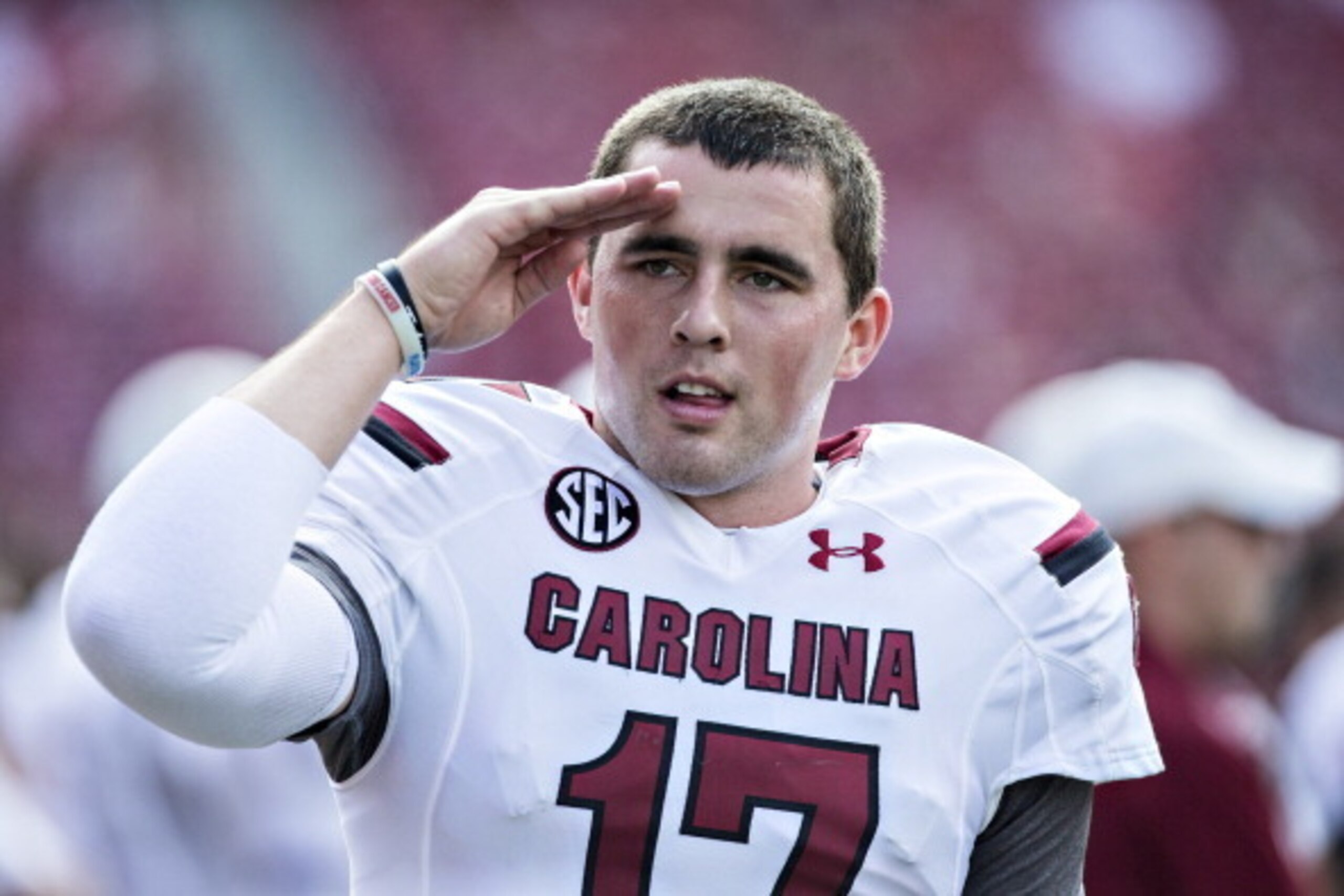 FAYETTEVILLE, AR - OCTOBER 12: Dylan Thompson #17 of the South Carolina Gamecocks salutes to someone in the crowd during a game against the Arkansas Razorbacks at Razorback Stadium on October 12, 2013 in Fayetteville, Arkansas. The Gamecocks defeated the 