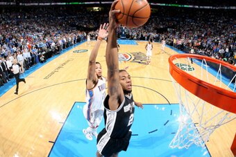 OKLAHOMA CITY, OK - APRIL 03: Kawhi Leonard #2 of the San Antonio Spurs dunks against the Oklahoma City Thunder on April 03, 2014 at the Chesapeake Energy Arena in Oklahoma City, Oklahoma. NOTE TO USER: User expressly acknowledges and agrees that, by down