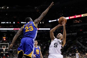 Apr 2, 2014; San Antonio, TX, USA; San Antonio Spurs guard Tony Parker (9) shoots the ball over Golden State Warriors forward Draymond Green (23) during the second half at AT&T Center. The Spurs won 111-90. Mandatory Credit: Soobum Im-USA TODAY Sports