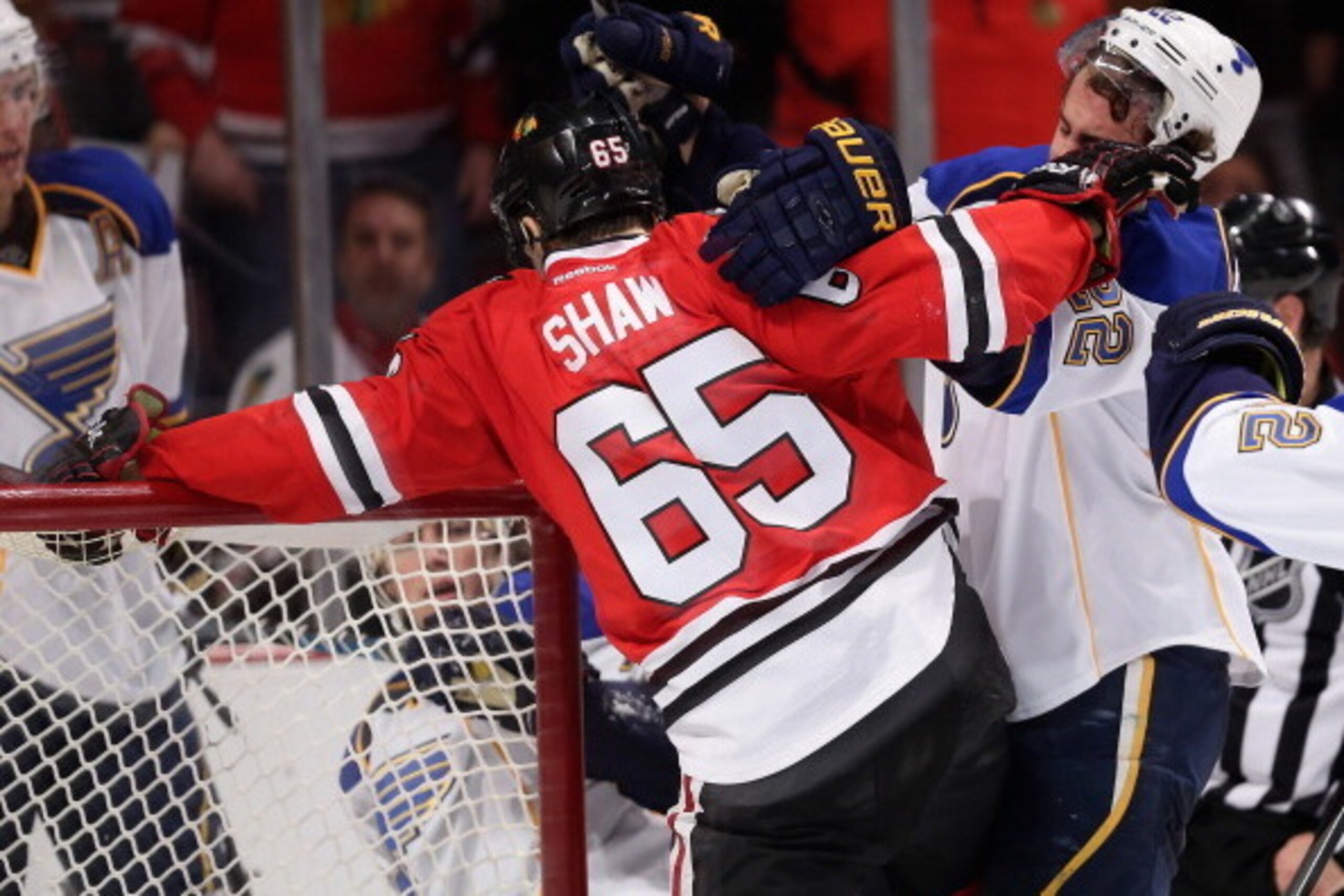 CHICAGO, IL - APRIL 06: Patrick Shaw #65 of the Chicago Blackhawks tangles with Kevin Shattenkirk #22 of the St. Louis Blues at the United Center on April 6, 2014  in Chicago, Illinois. The Blackhawks defeated the Blues 4-2. (Photo by Jonathan Daniel/Gett