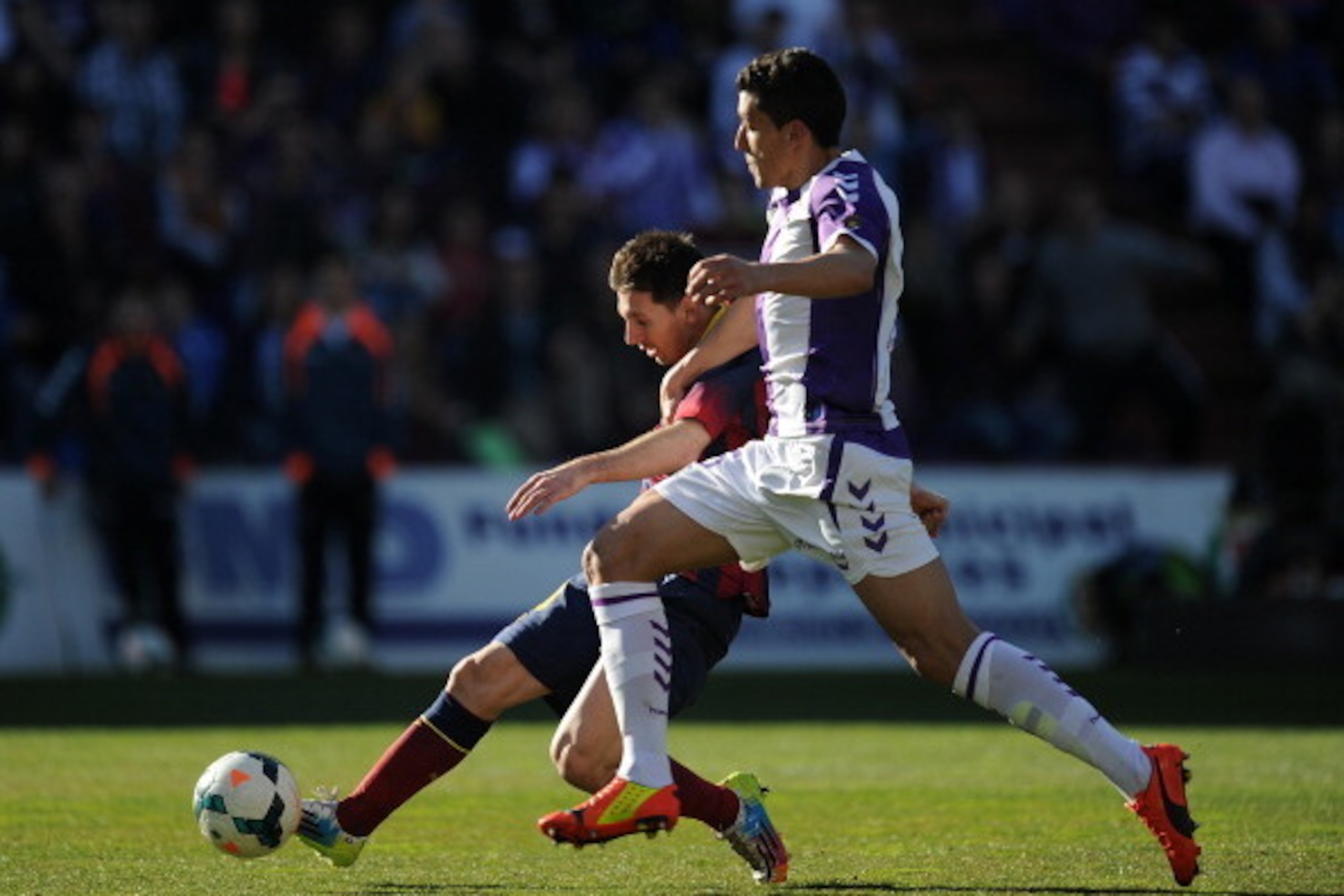 VALLADOLID, SPAIN - MARCH 08:  Lionel Messi (L) of FC Barcelona is tackled by  Stefan Mitrovic of Valladolid CF during the La Liga match between Real Valladolid CF and FC Barcelona at estadio Nuevo Jose Zorillo on March 8, 2014 in Valladolid, Spain.  (Pho