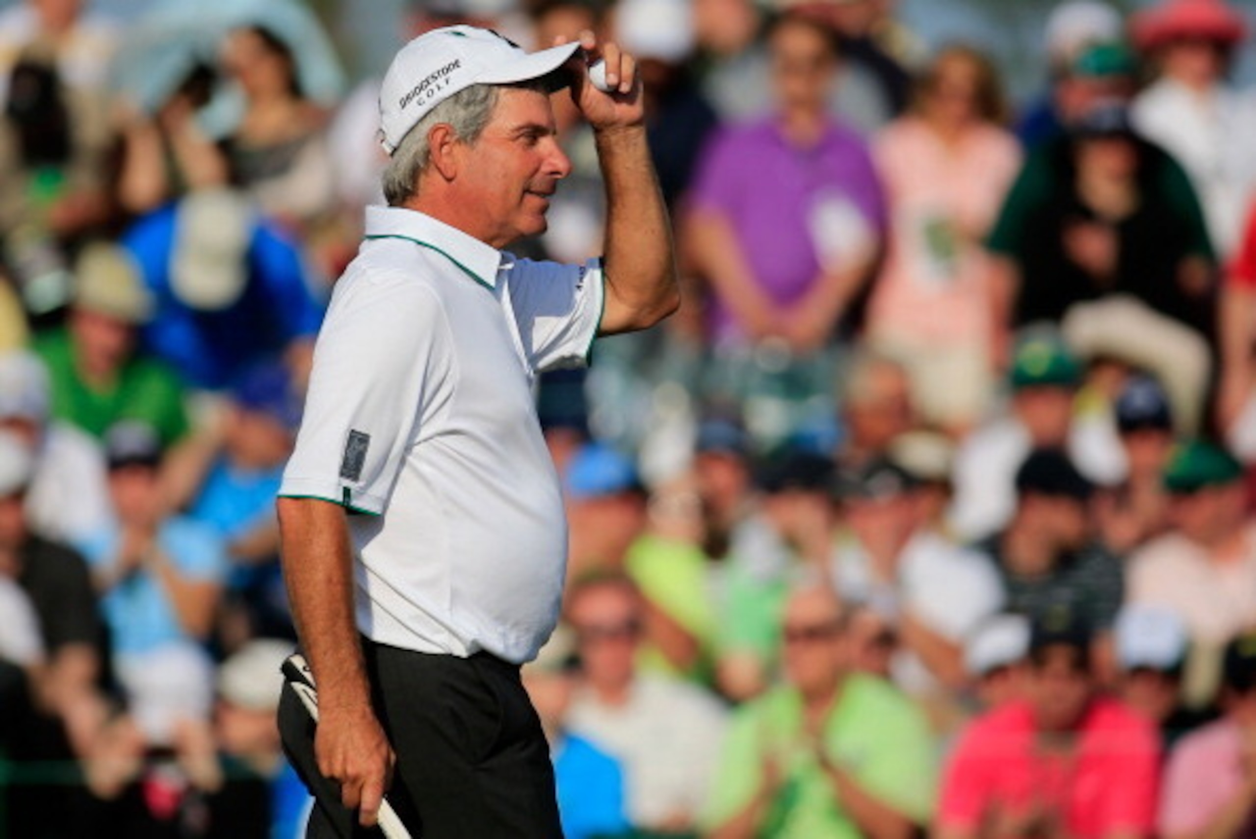 AUGUSTA, GA - APRIL 11:  Fred Couples of the United States walks across the 18th green during the second round of the 2014 Masters Tournament at Augusta National Golf Club on April 11, 2014 in Augusta, Georgia.  (Photo by Rob Carr/Getty Images)