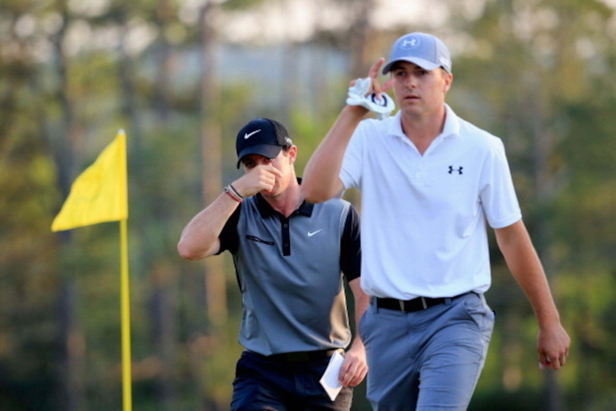 AUGUSTA, GA - APRIL 11:  Jordan Spieth of the United States and Rory McIlroy of Northern Ireland walk off the 18th green during the second round of the 2014 Masters Tournament at Augusta National Golf Club on April 11, 2014 in Augusta, Georgia.  (Photo by