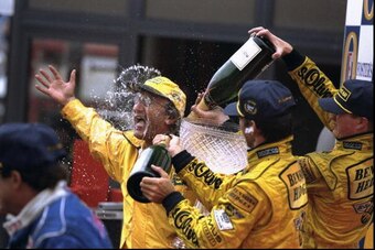 30 Aug 1998:  Jordan boss Eddie Jordan (left) is sprayed with champagne by winner Damon Hill (right front) of Great Britain and Ralf Schumacher (rear) of Germany both of Jordan Mugen Honda at the Belgian Grand Prix at Spa-Francorchamps in Belgium. \ Manda