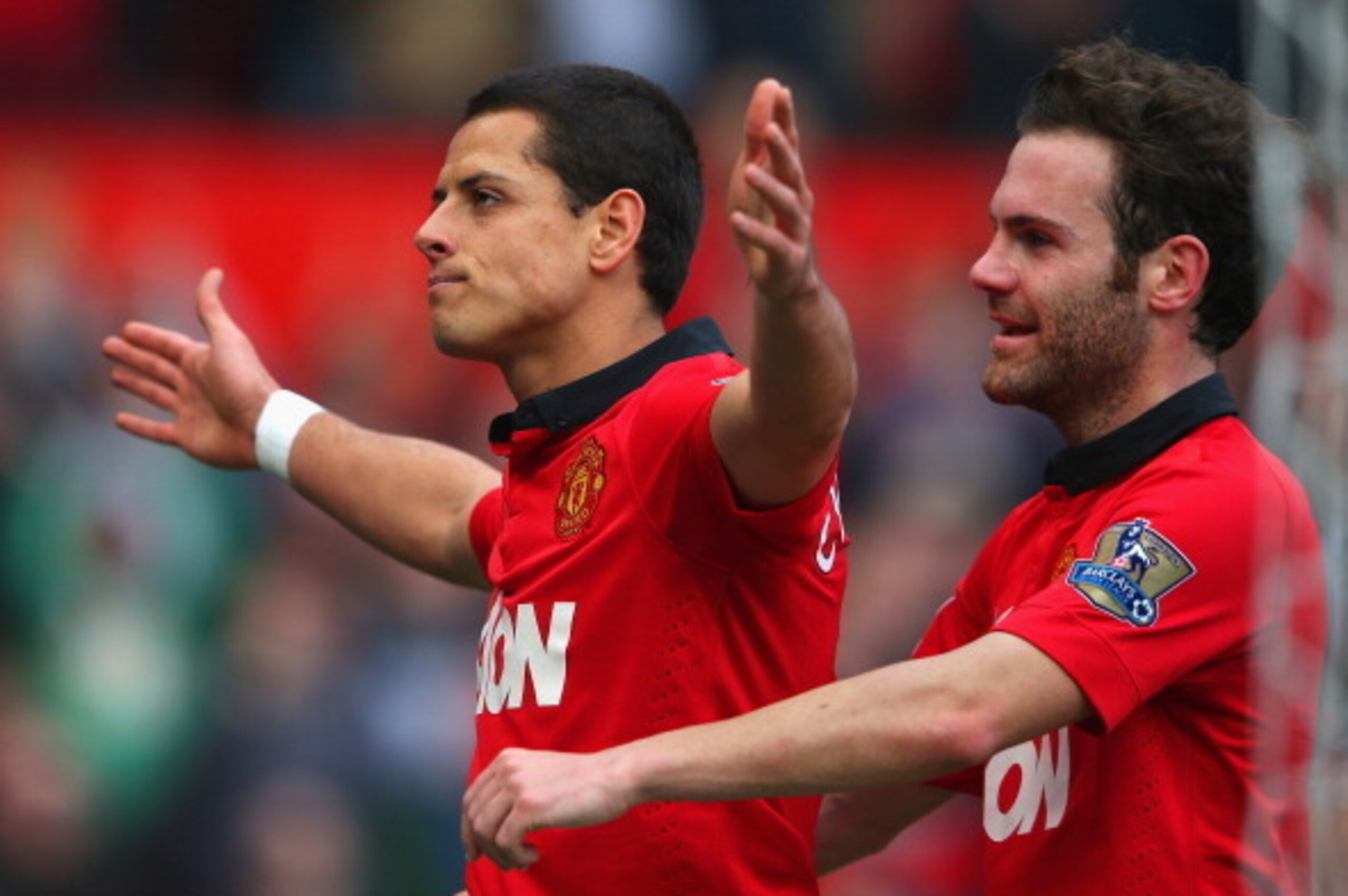 MANCHESTER, ENGLAND - MARCH 29:  Javier Hernandez of Manchester United celebrates scoring his team's fourth goal with Juan Mata (R) during the Barclays Premier League match between Manchester United and Aston Villa at Old Trafford on March 29, 2014 in Man