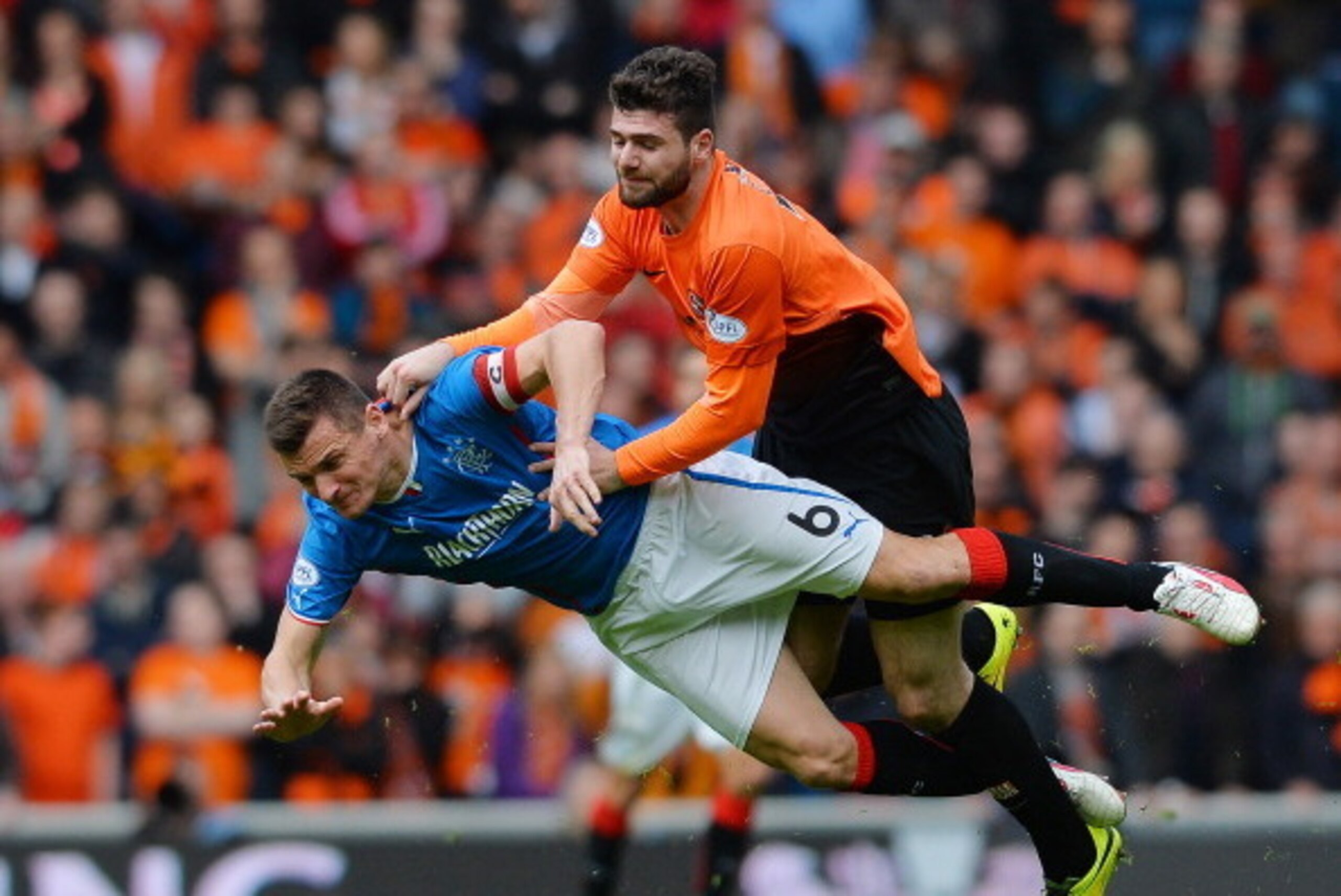 GLASGOW, SCOTLAND - APRIL 12: Lee McCulloch of Rangers and Nadir Ciftci of Dundee United collide during the William Hill Scottish Cup Semi Final between Rangers and Dundee United at Ibrox Stadium on April 12, 2014 in Glasgow, Scotland. (Photo by Mark Runn