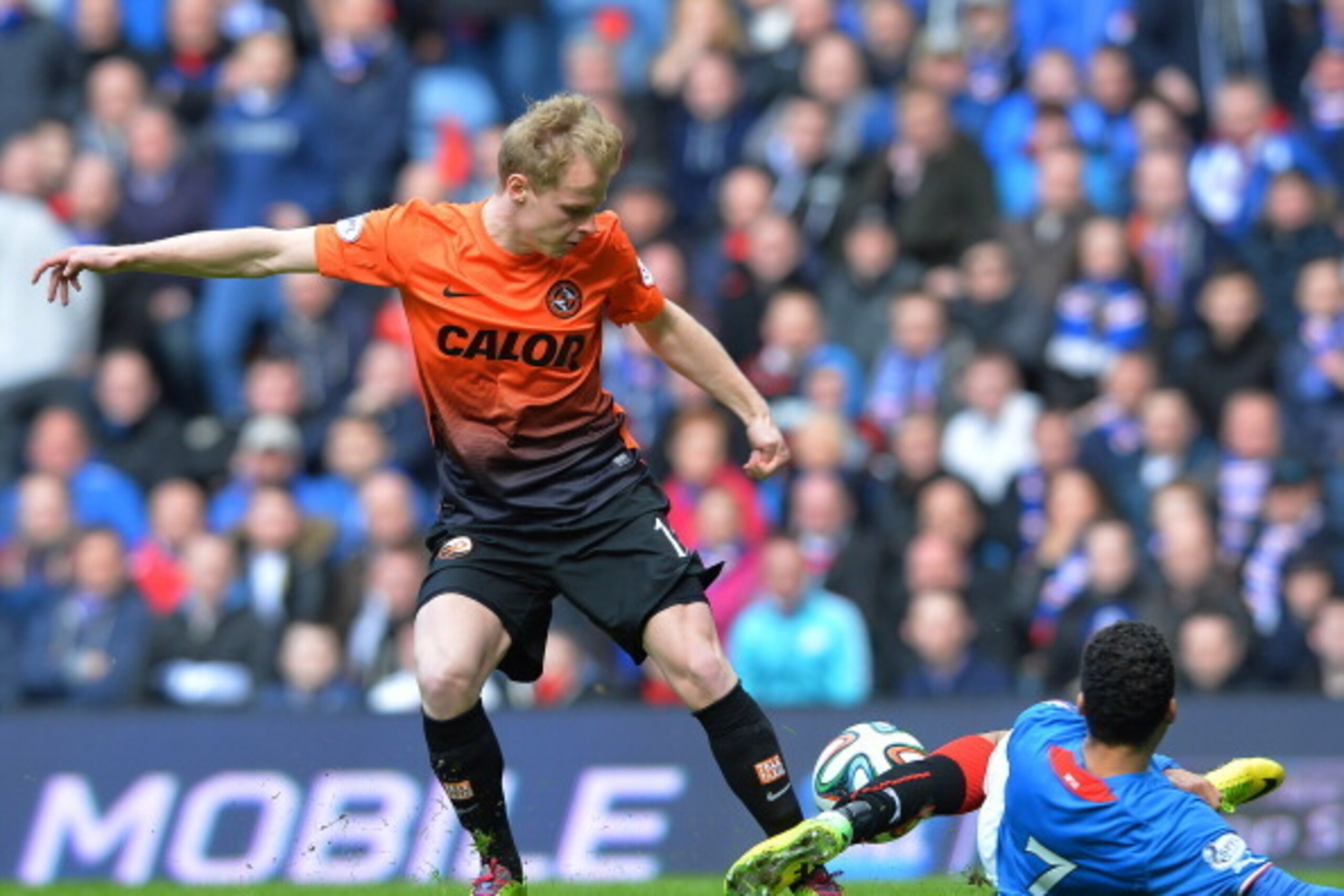GLASGOW, SCOTLAND - APRIL 12:  Arnold Peralta of Rangers tackles Gary Mackey-Steven of Dundee United during the William Hill Scottish Cup Semi Final between Rangers and Dundee United at Ibrox Stadium on April 12, 2014 in Glasgow, Scotland. (Photo by Mark 