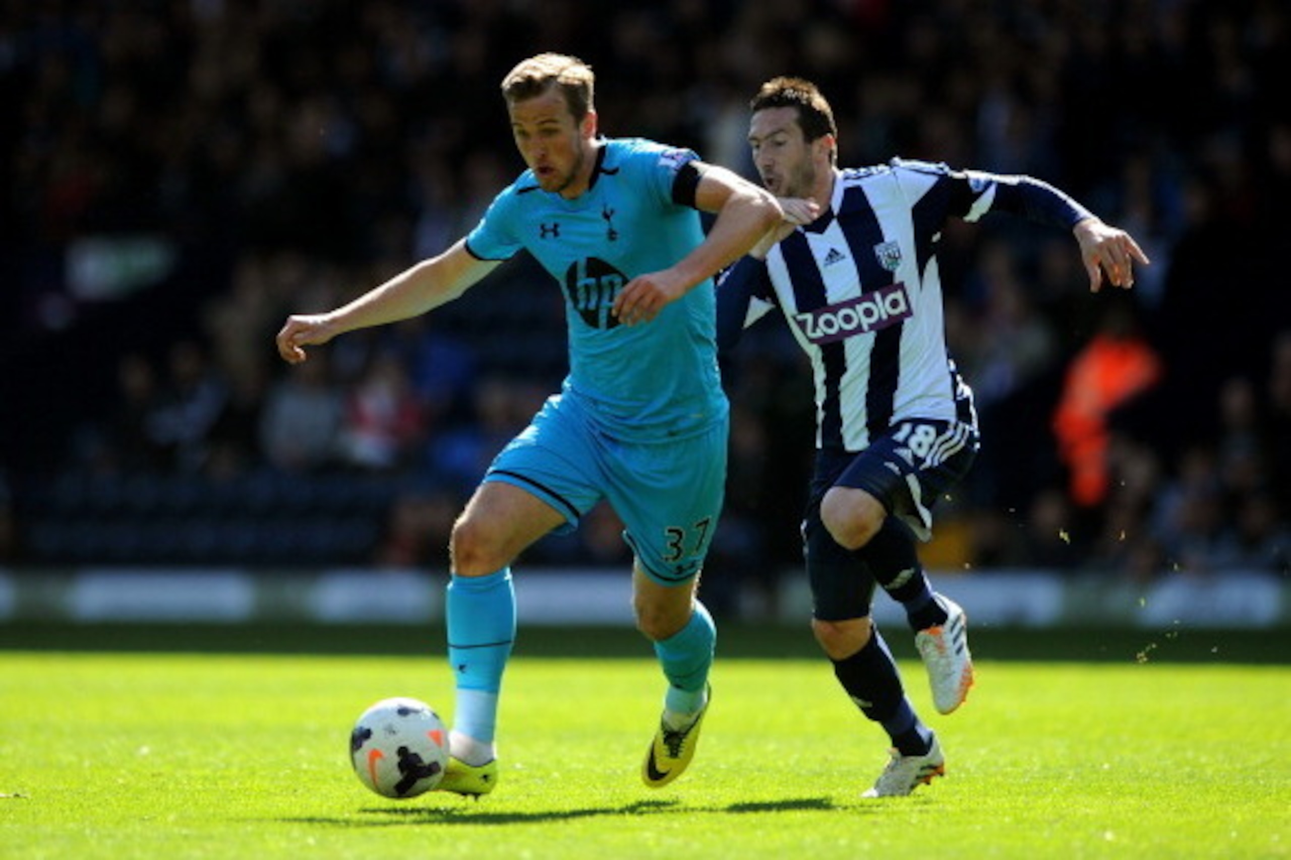 WEST BROMWICH, ENGLAND - APRIL 12:  Harry Kane of Spurs is pursued by Morgan Amalfitano of West Bromwich during the Barclays Premier League match between West Bromwich Albion and Tottenham Hotspur at The Hawthorns on April 12, 2014 in West Bromwich, Engla
