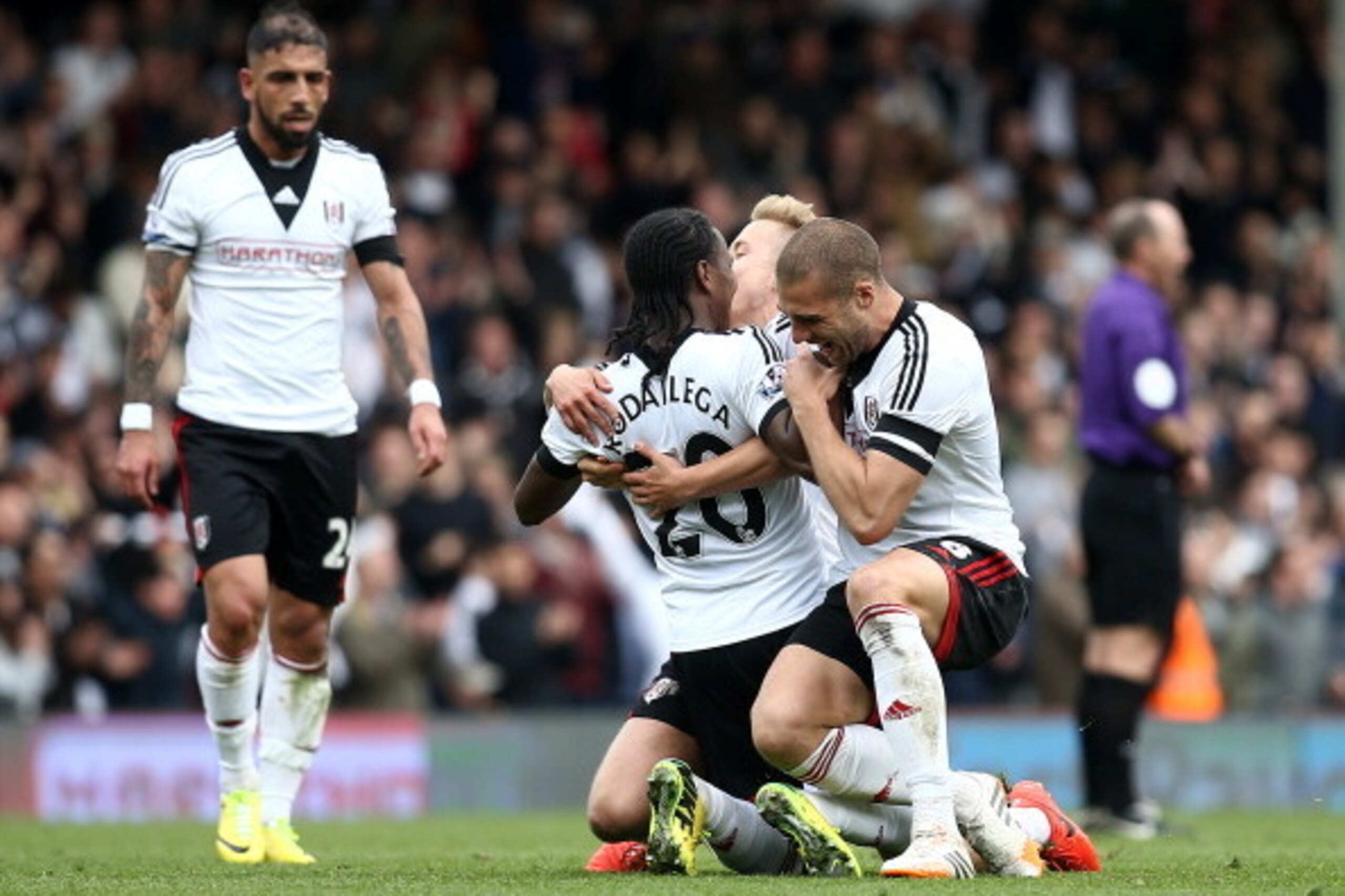 LONDON, ENGLAND - APRIL 12: Hugo Rodallega of Fulham celebrates the teams win with Lewis Holtby and Pajtim Kasami at the final whistle during the Barclays Premier League match between Fulham and Norwich City at Craven Cottage on April 12, 2014 in London, LONDON, ENGLAND - APRIL 12: Hugo Rodallega of Fulham celebrates the teams win with Lewis Holtby and Pajtim Kasami at the final whistle during the Barclays Premier League match between Fulham and Norwich City at Craven Cottage on April 12, 2014 in London,