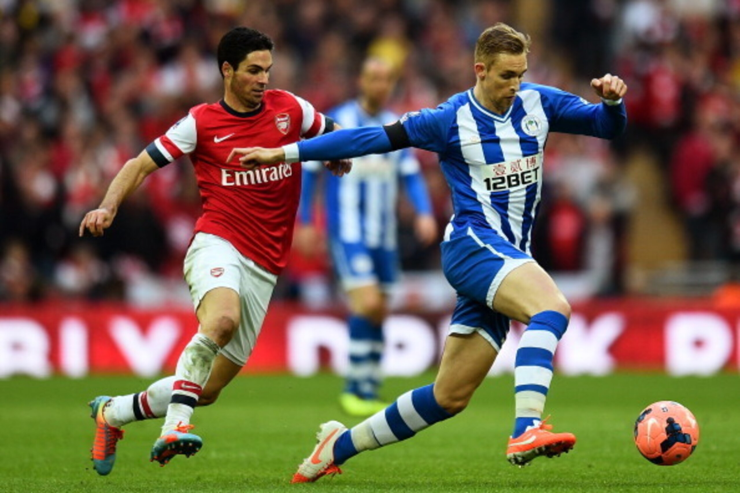 LONDON, ENGLAND - APRIL 12:  Mikel Arteta of Arsenal marshalls Callum McManaman of Wigan Athletic during the FA Cup Semi-Final match between Wigan Athletic and Arsenal at Wembley Stadium on April 12, 2014 in London, England.  (Photo by Shaun Botterill/Get