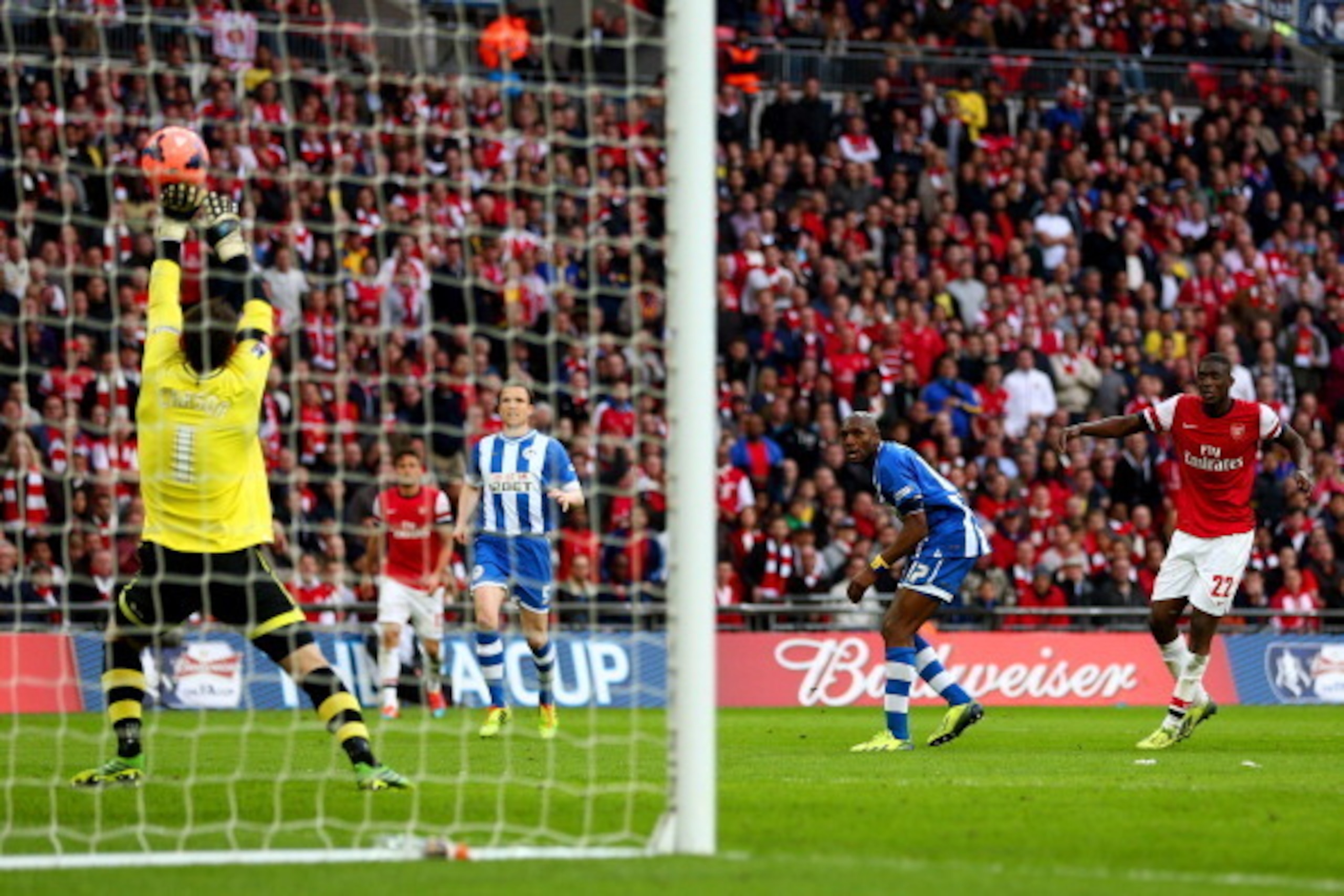 LONDON, ENGLAND - APRIL 12:  Scott Carson of Wigan Athletic makes a save from Yaya Sanogo of Arsenal during the FA Cup Semi-Final match between Wigan Athletic and Arsenal at Wembley Stadium on April 12, 2014 in London, England.  (Photo by Michael Steele/G
