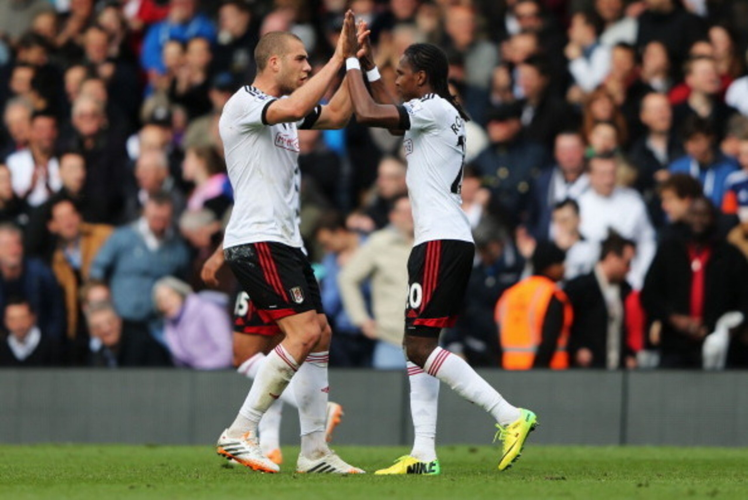 LONDON, ENGLAND - APRIL 12:  Hugo Rodallega of Fulham (R) celebrates with Pajtim Kasami as he scores their first goal during the Barclays Premier League match between Fulham and Norwich City at Craven Cottage on April 12, 2014 in London, England.  (Photo 