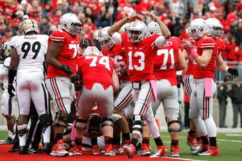 COLUMBUS, OH - OCTOBER 20:  Ken Guiton #13 of the Ohio State Buckeyes celebrates after Carlos Hyde #34 of the Ohio State Buckeyes scored during overtime against the Purdue Boilermakers on October 20, 2012 at Ohio Stadium in Columbus, Ohio. (Photo by Kirk
