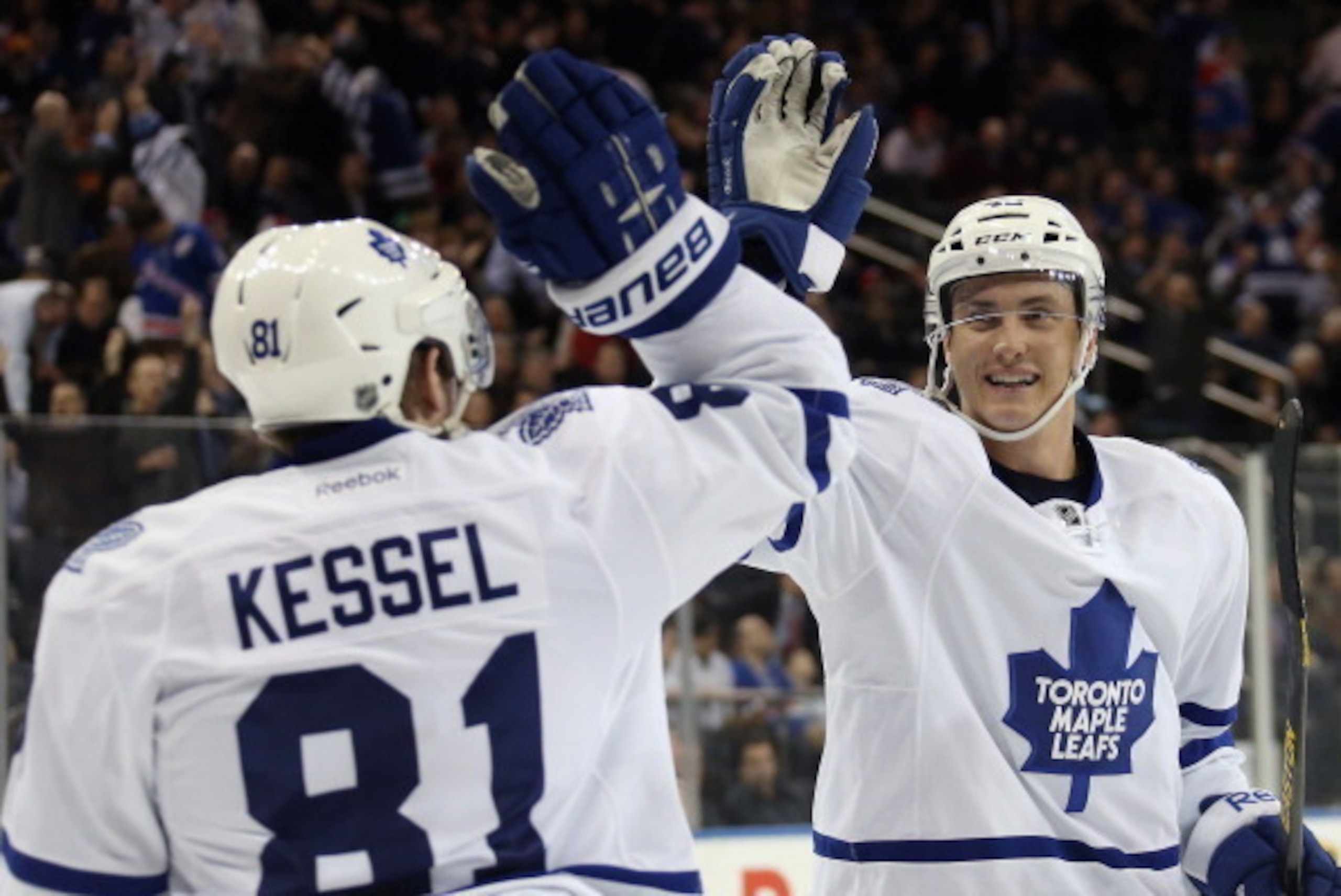 NEW YORK, NY - MARCH 05:  Tyler Bozak #42 of the Toronto Maple Leafs (R) celebrates his goal at 1:51 of overtime along with Phil Kessel #81 (L) to defeat the New York Rangers 3-2 at Madison Square Garden on March 5, 2014 in New York City.  (Photo by Bruce