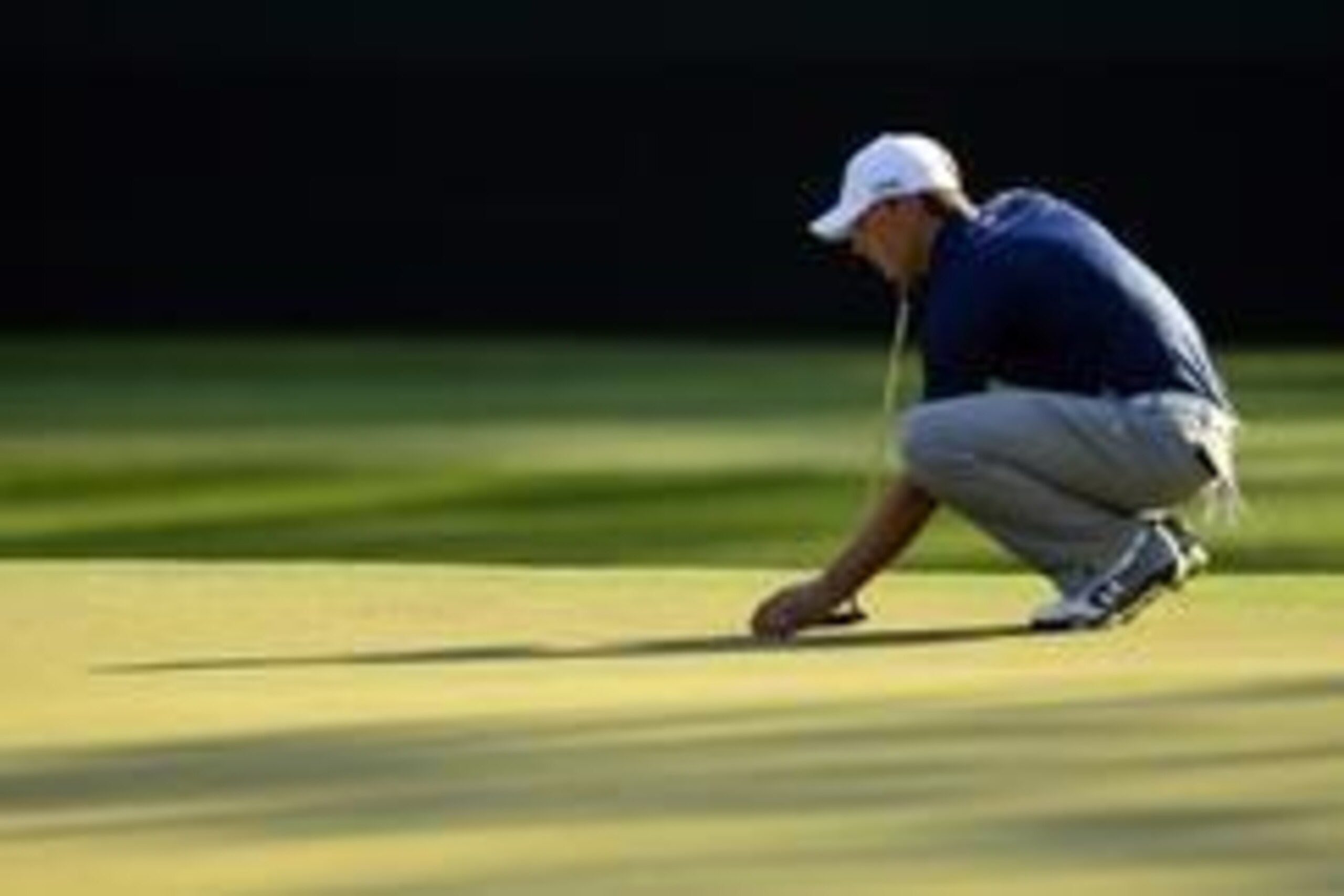 Apr 12, 2014; Augusta, GA, USA; Jordan Spieth places his ball on the 15th green during the third round of the 2014 The Masters golf tournament at Augusta National Golf Club. Mandatory Credit: Michael Madrid-USA TODAY Sports