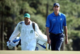 AUGUSTA, GA - APRIL 12:  Matt Kuchar of the United States walks to the 18th green with his caddie Lance Bennett during the third round of the 2014 Masters Tournament at Augusta National Golf Club on April 12, 2014 in Augusta, Georgia.  (Photo by Andrew Re