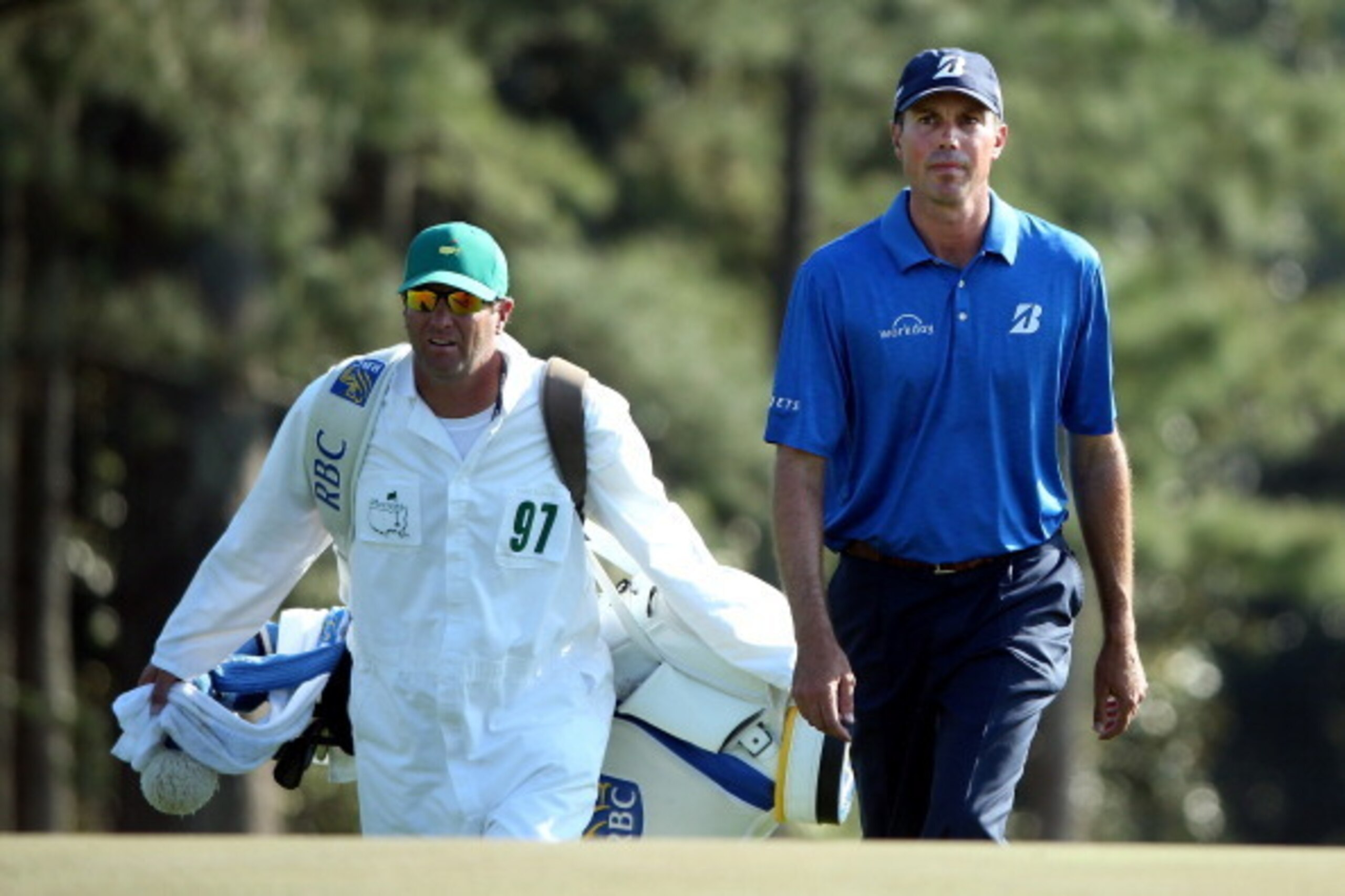 AUGUSTA, GA - APRIL 12:  Matt Kuchar of the United States walks to the 18th green with his caddie Lance Bennett during the third round of the 2014 Masters Tournament at Augusta National Golf Club on April 12, 2014 in Augusta, Georgia.  (Photo by Andrew Re