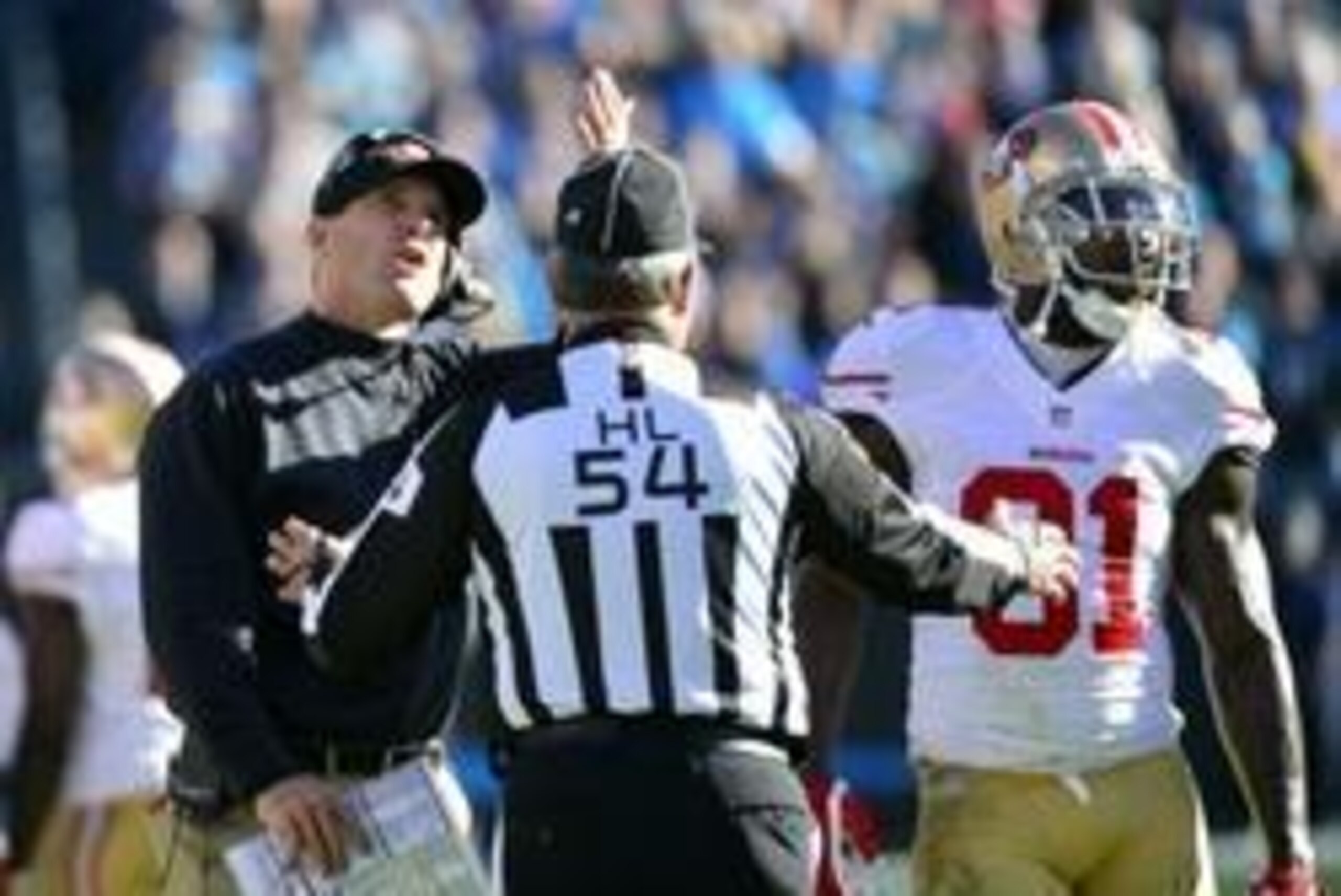 Jan 12, 2014; Charlotte, NC, USA; San Francisco 49ers head coach Jim Harbaugh questions a call during the third quarter of the 2013 NFC divisional playoff football game against the Carolina Panthers at Bank of America Stadium. Mandatory Credit: Bob Donnan