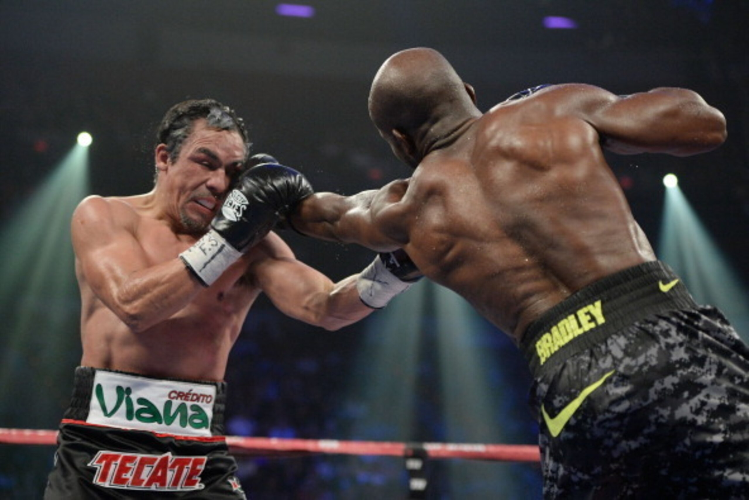 LAS VEGAS, NV - OCTOBER 12:  WBO welterweight champion Timothy Bradley Jr. (R) lands a left jab ot the head of Juan Manuel Marquez during their bout at the Thomas & Mack Center on October 12, 2013 in Las Vegas, Nevada. Timothy Bradley Jr. wins in a split-