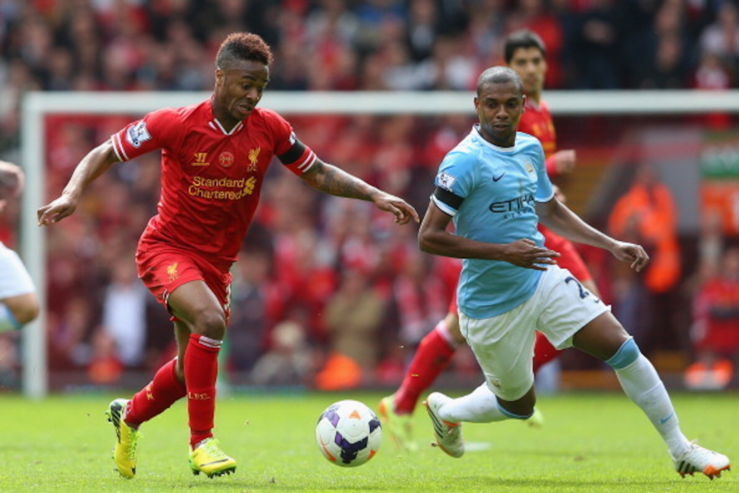 LIVERPOOL, ENGLAND - APRIL 13:  Raheem Sterling of Liverpool competes with Fernandinho of Manchester City during the Barclays Premier League match between Liverpool and Manchester City at Anfield on April 13, 2014 in Liverpool, England.  (Photo by Alex Li