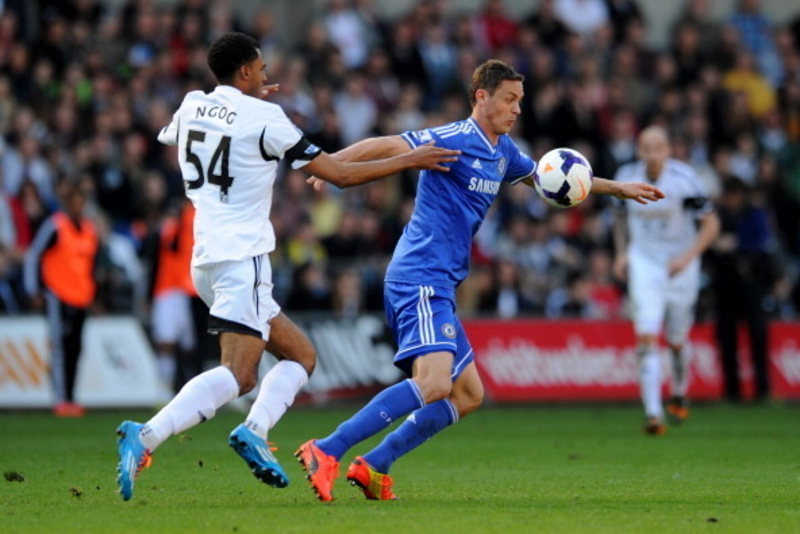 SWANSEA, WALES - APRIL 13:  Nemanja Matic of Chelsea holds off the challenge from David N'Gog of Swansea during the Barclays Premier League match between Swansea City and Chelsea at Liberty Stadium on April 13, 2014 in Swansea, Wales.  (Photo by Chris Bru