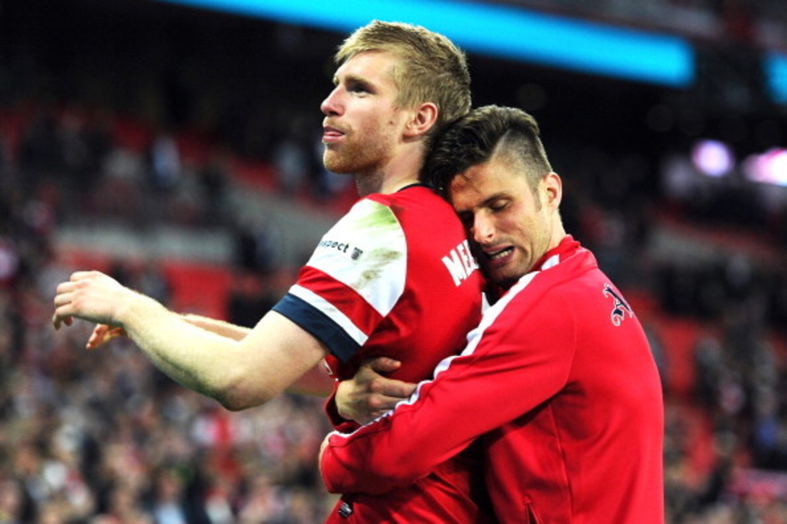 LONDON, ENGLAND - APRIL 12:  Per Mertesacker and Olivier Giroud of Arsenal celebrate victory during the FA Cup Semi-Final match between Wigan Athletic and Arsenal at Wembley Stadium on April 12, 2014 in London, England.  (Photo by Mike Hewitt/Getty Images