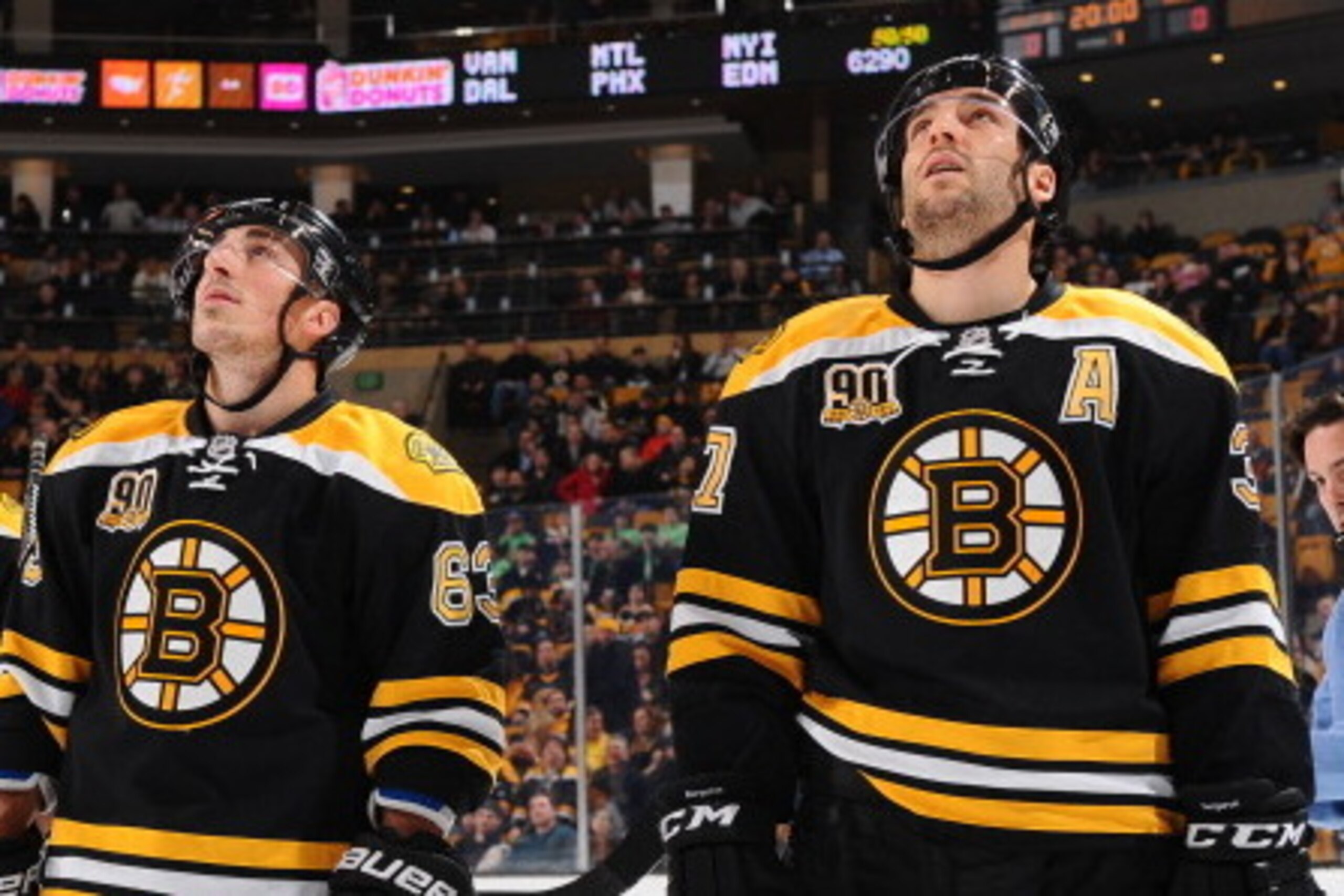 BOSTON, MA - MARCH 6: Jordan Caron #18, Brad Marchand #63 and Patrice Bergeron #37 of the Boston Bruins watch a video on the jumbotron before the game against the Washington Capitals at the TD Garden on March 6, 2014 in Boston, Massachusetts.  (Photo by B