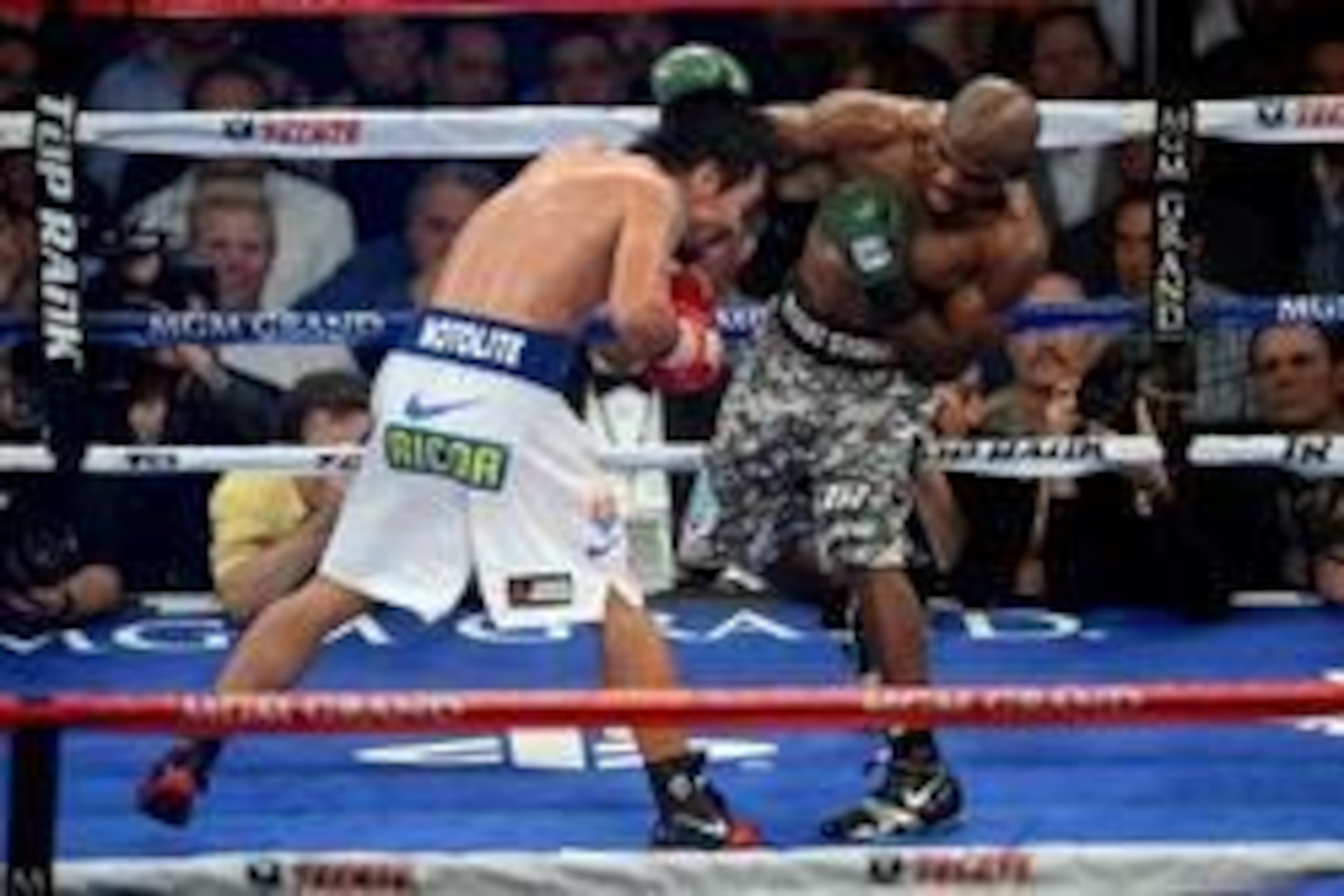 Apr 12, 2014; Las Vegas, NV, USA; Timothy Bradley (green gloves) and Manny Pacquiao (red gloves) box during their WBO World Welterweight Title bout at MGM Grand Garden Arena. Pacquiao won via unanimous decision. Mandatory Credit: Joe Camporeale-USA TODAY 