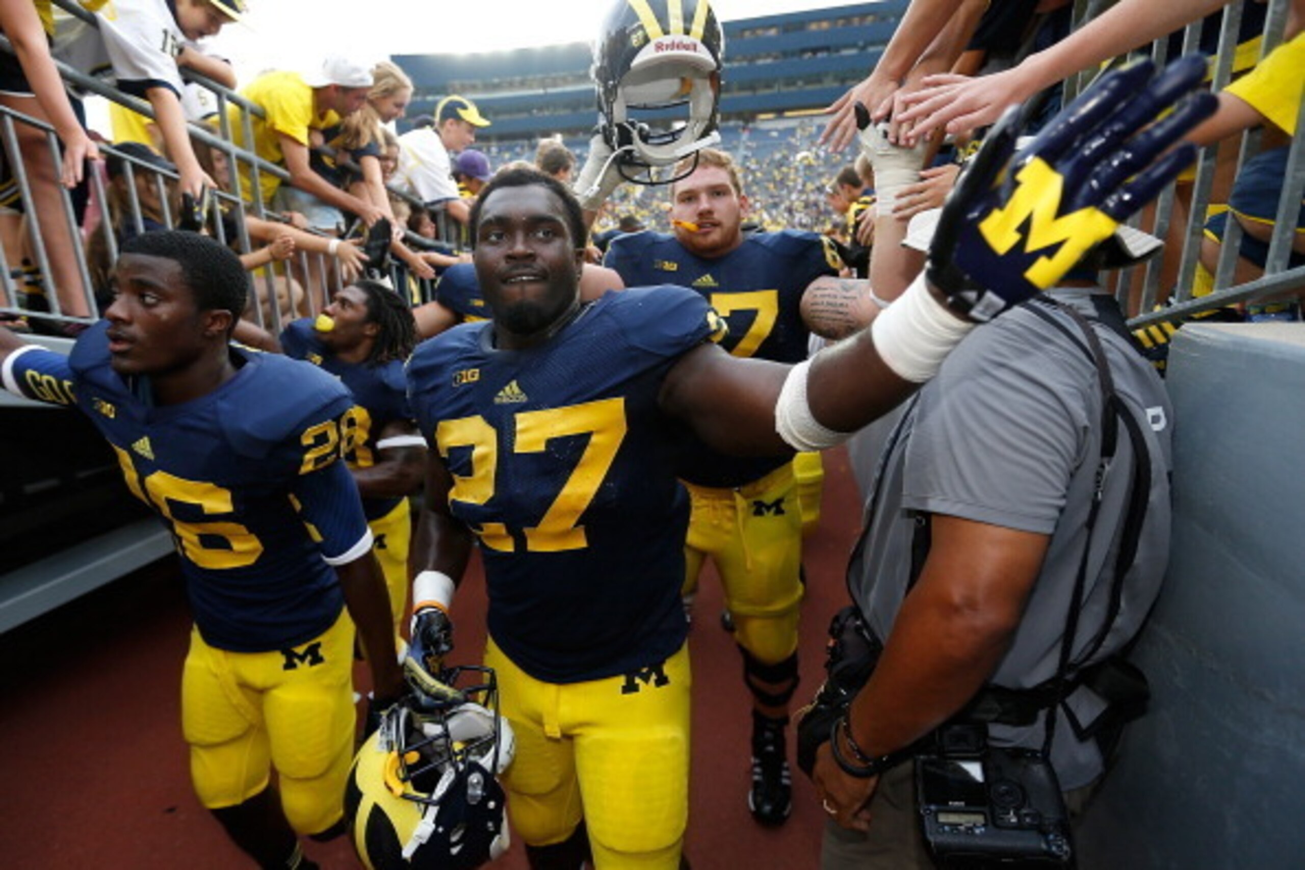 ANN ARBOR, MI - AUGUST 31: Jourdan Lewis #26 and Derrick Green #27 of the Michigan Wolverines leave the field after a 59-9 win over the Central Michigan Chippewas at Michigan Stadium on August 31, 2013 in Ann Arbor, Michigan.  (Photo by Gregory Shamus/Get