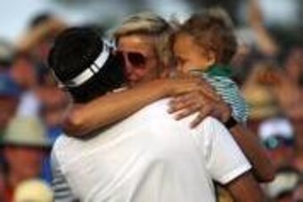 Apr 13, 2014; Augusta, GA, USA; Bubba Watson hugs wife Angie Watson and son Caleb Watson after winning the 2014 The Masters golf tournament at Augusta National Golf Club. Mandatory Credit: Jack Gruber-USA TODAY Sports