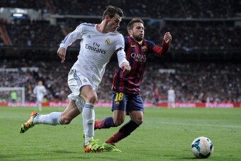 MADRID, SPAIN - MARCH 23:  Gareth Bale (L) of Real Madrid takes on Jordi Alba of Barcelona during the La Liga match between Real Madrid CF and FC Barcelona at the Bernabeu on March 23, 2014 in Madrid, Spain. (Photo by Denis Doyle/Getty Images)