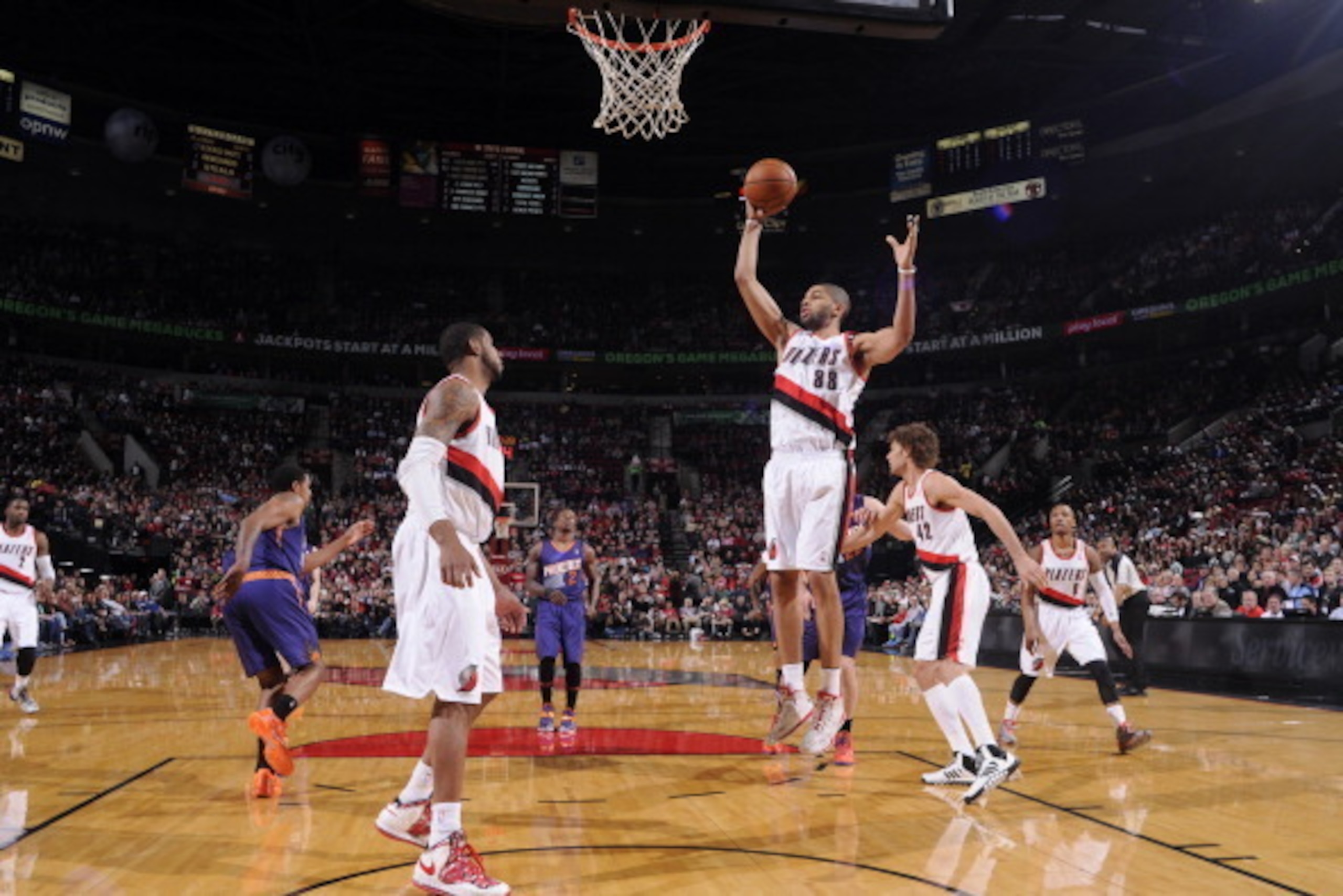 PORTLAND, OR - APRIL 4: Nicolas Batum #88 of the Portland Trail Blazers grabs a rebound against the Phoenix Suns on April 4, 2014 at the Moda Center Arena in Portland, Oregon. NOTE TO USER: User expressly acknowledges and agrees that, by downloading and o