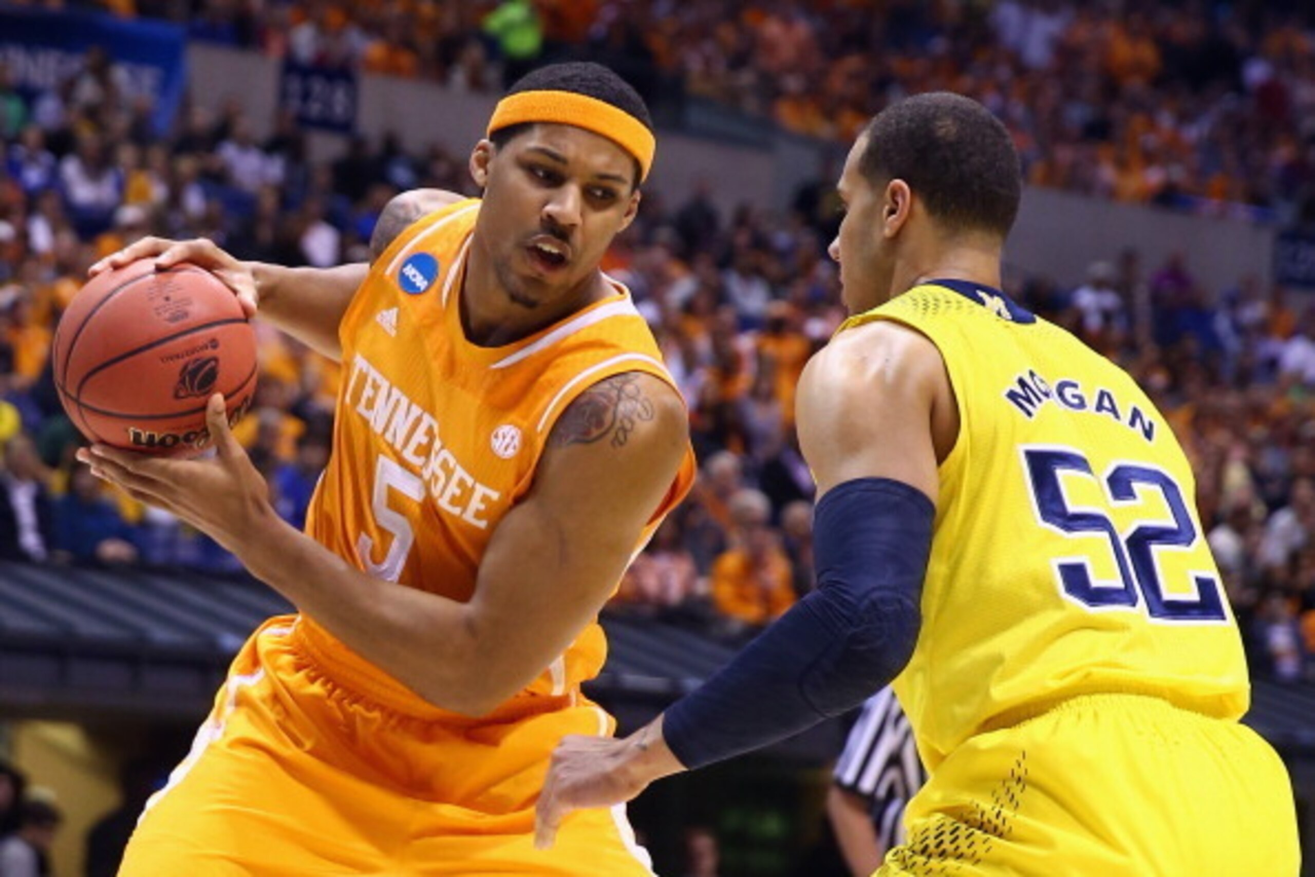 INDIANAPOLIS, IN - MARCH 28:  Jarnell Stokes #5 of the Tennessee Volunteers drives to the basket against Jordan Morgan #52 of the Michigan Wolverines in the first half during the regional semifinal of the 2014 NCAA Men's Basketball Tournament at Lucas Oil