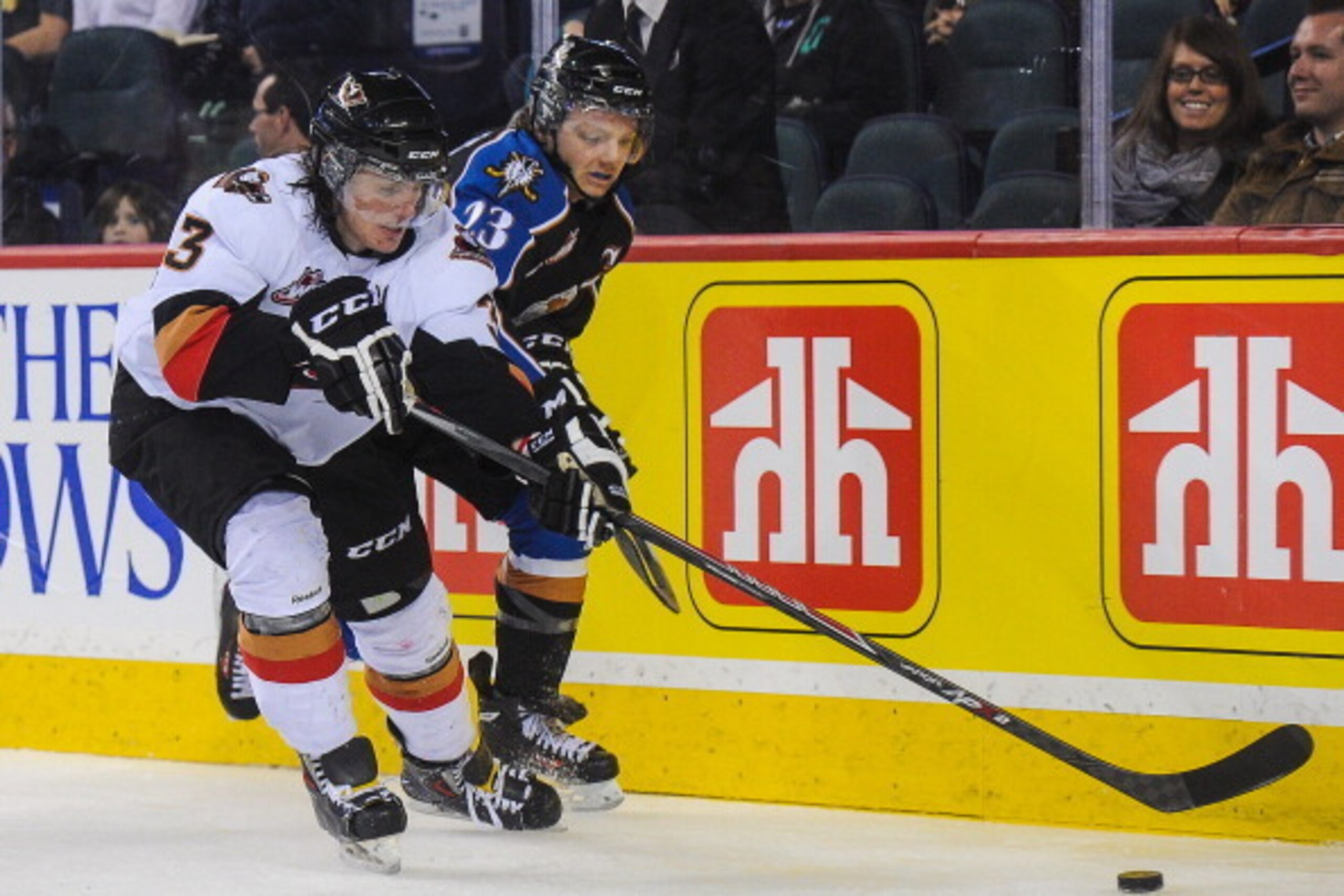 CALGARY, AB - MARCH 15: Kenton Helgesen #3 of the Calgary Hitmen battles for the puck against Sam Reinhart #23 of the Kootenay Ice during a WHL game at Scotiabank Saddledome on March 15, 2014 in Calgary, Alberta, Canada. (Photo by Derek Leung/Getty Images CALGARY, AB - MARCH 15: Kenton Helgesen #3 of the Calgary Hitmen battles for the puck against Sam Reinhart #23 of the Kootenay Ice during a WHL game at Scotiabank Saddledome on March 15, 2014 in Calgary, Alberta, Canada. (Photo by Derek Leung/Getty Images