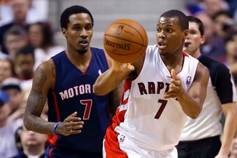 Apr 13, 2014; Auburn Hills, MI, USA; Toronto Raptors guard Kyle Lowry (7) passes the ball away from Detroit Pistons guard Brandon Jennings (7) in the second half at The Palace of Auburn Hills. Mandatory Credit: Rick Osentoski-USA TODAY Sports