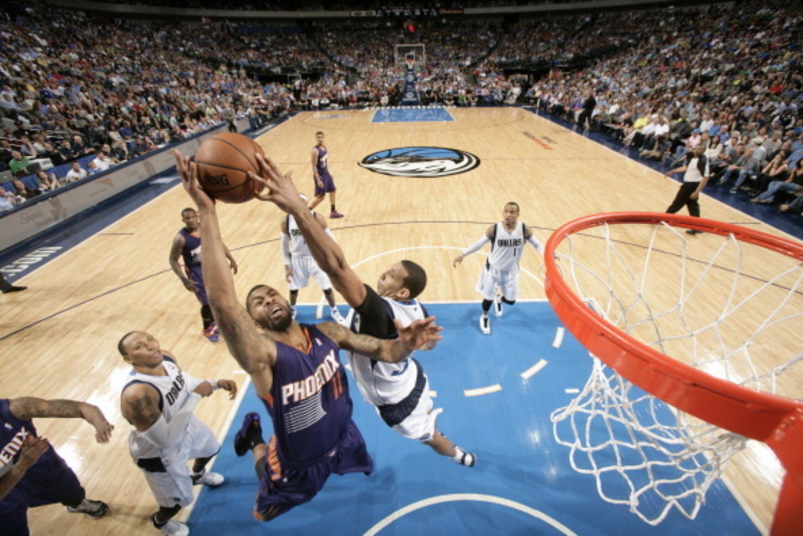 DALLAS, TX - APRIL 12: Brandan Wright #34 of the Dallas Mavericks blocks a shot against Markieff Morris #11 of the Phoenix Suns on April 12, 2014 at the American Airlines Center in Dallas, Texas. NOTE TO USER: User expressly acknowledges and agrees that, 
