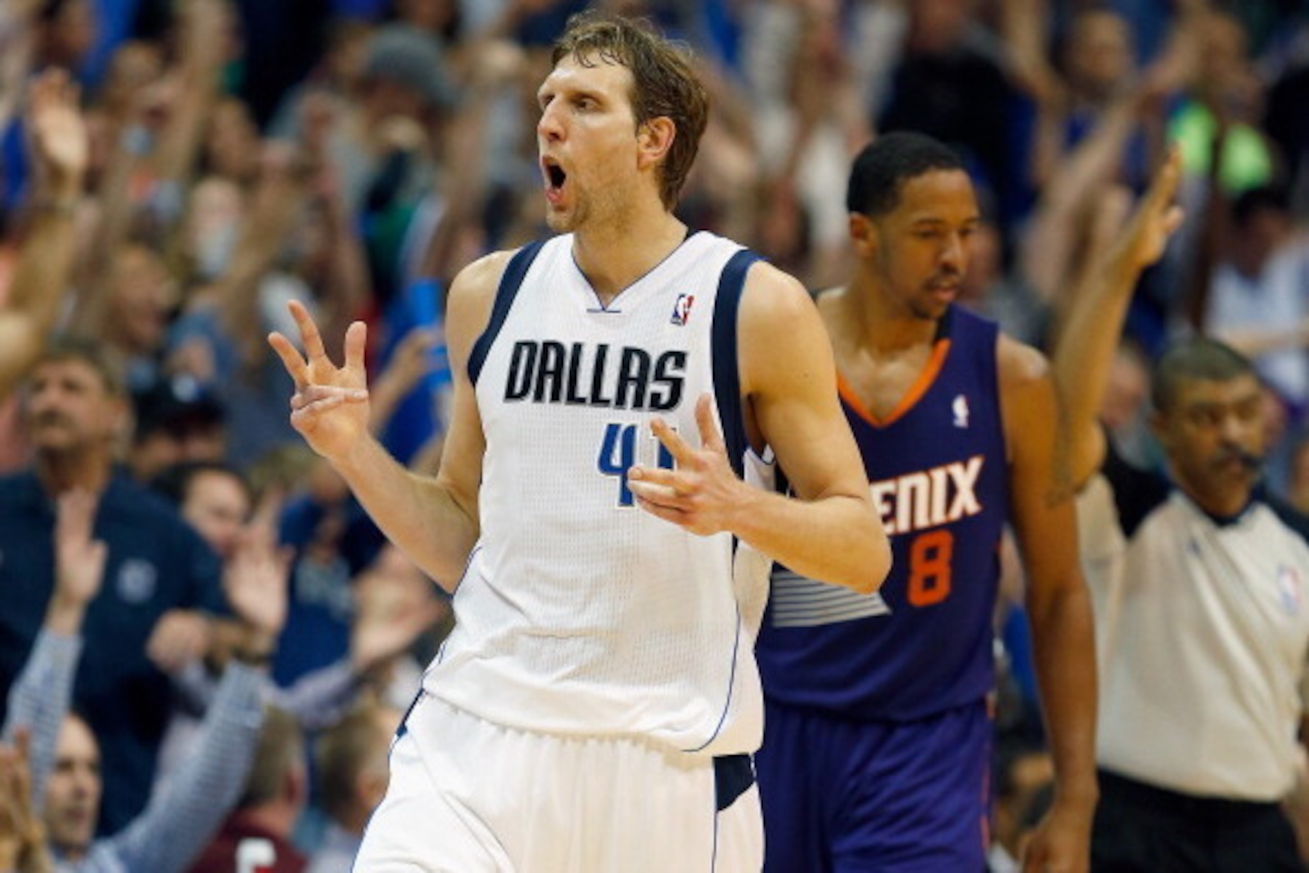 DALLAS, TX - APRIL 12:  Dirk Nowitzki #41 of the Dallas Mavericks reacts after making a three point shot against the Phoenix Suns at American Airlines Center on April 12, 2014 in Dallas, Texas.  (Photo by Tom Pennington/Getty Images)