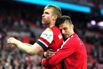 LONDON, ENGLAND - APRIL 12:  Per Mertesacker and Olivier Giroud of Arsenal celebrate victory during the FA Cup Semi-Final match between Wigan Athletic and Arsenal at Wembley Stadium on April 12, 2014 in London, England.  (Photo by Mike Hewitt/Getty Images